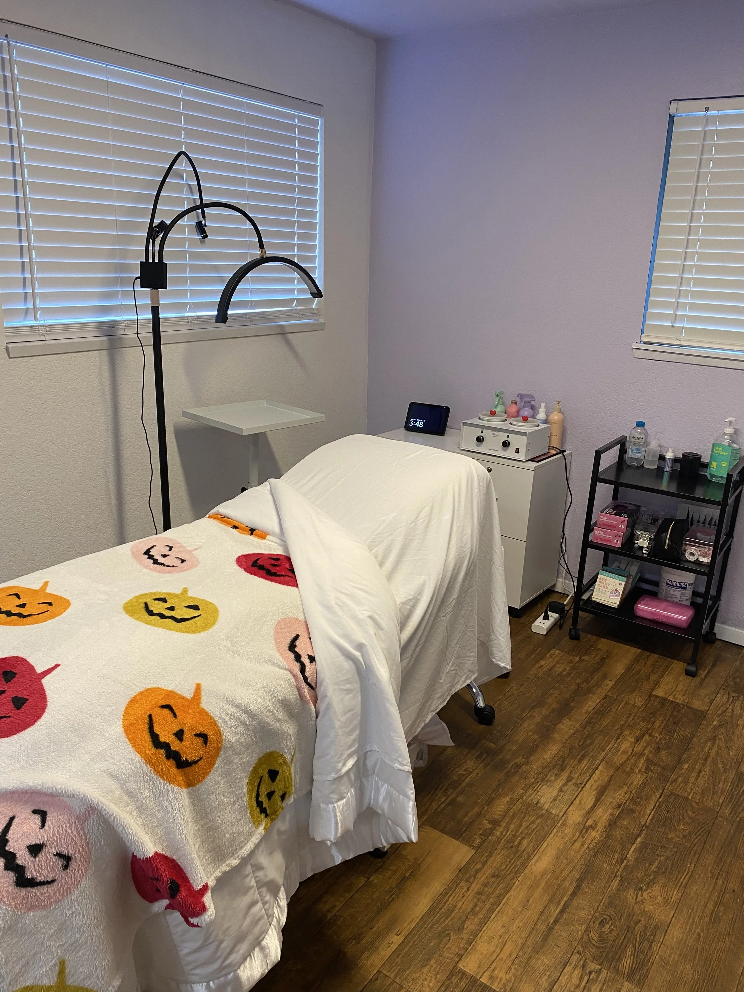 memory foam padded spa bed with halloween blanket and white sheets in a colorful room