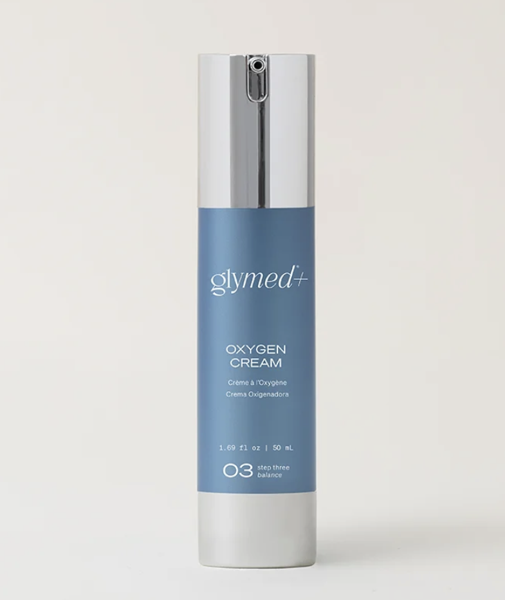 A bottle of glymed+ oxygen cream with a silver cap and light blue label.
