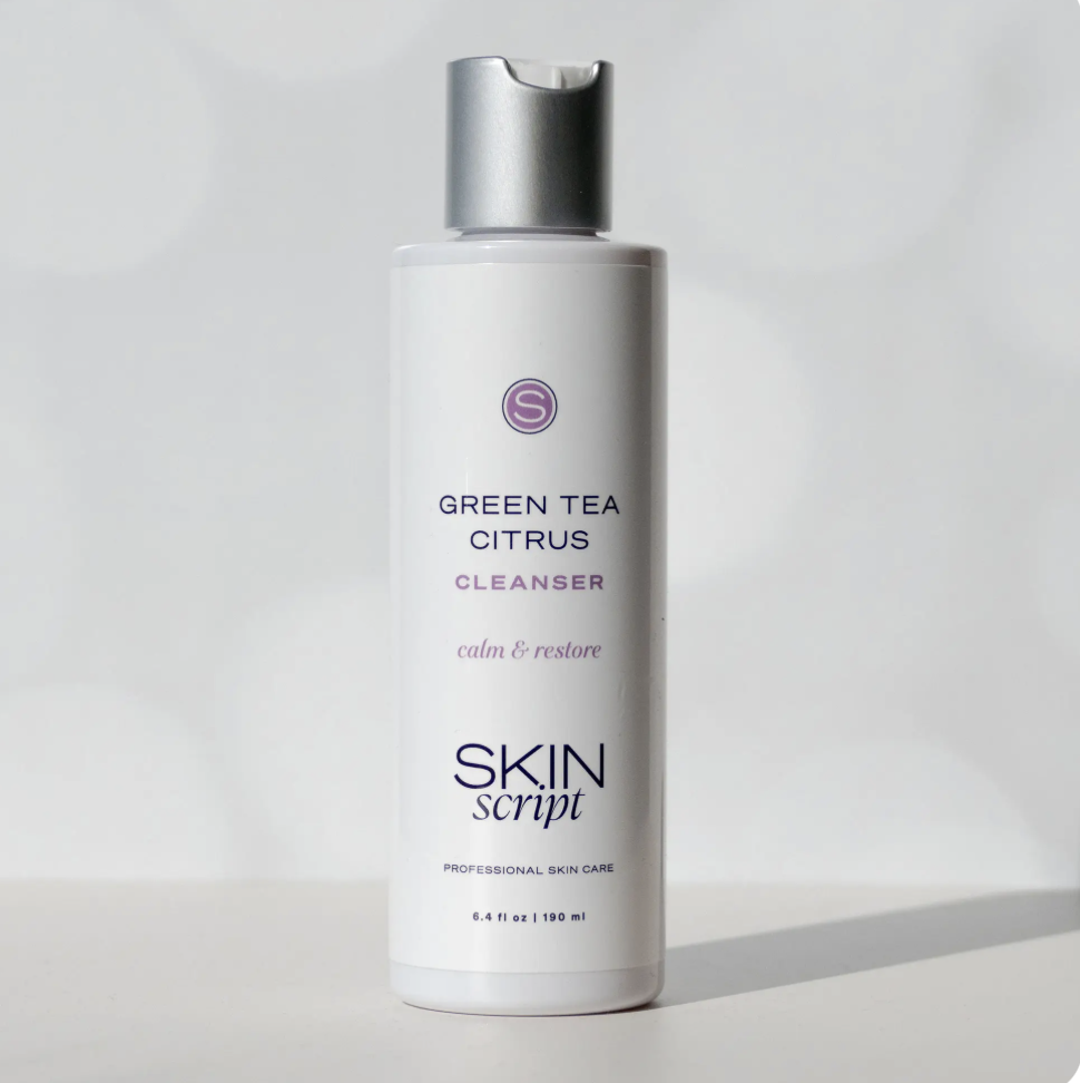 A white bottle of skin cleanser labeled 'Green Tea Citrus Cleanser' by Skin Script with a silver flip-top cap, standing on a white surface against a plain background.