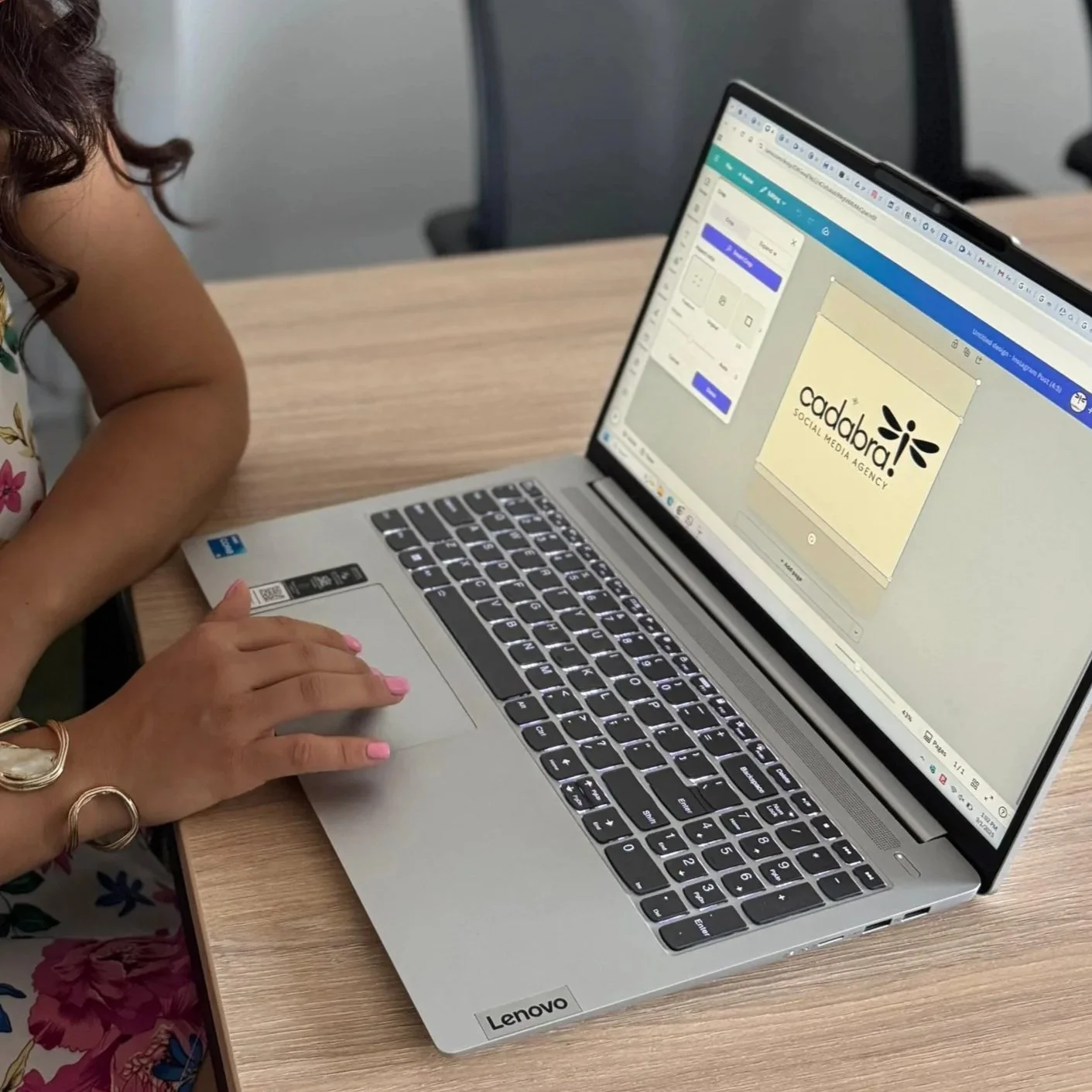 A graphic designer using Canva showing a logo for 'Cadabra Social Media Agency' on the screen.