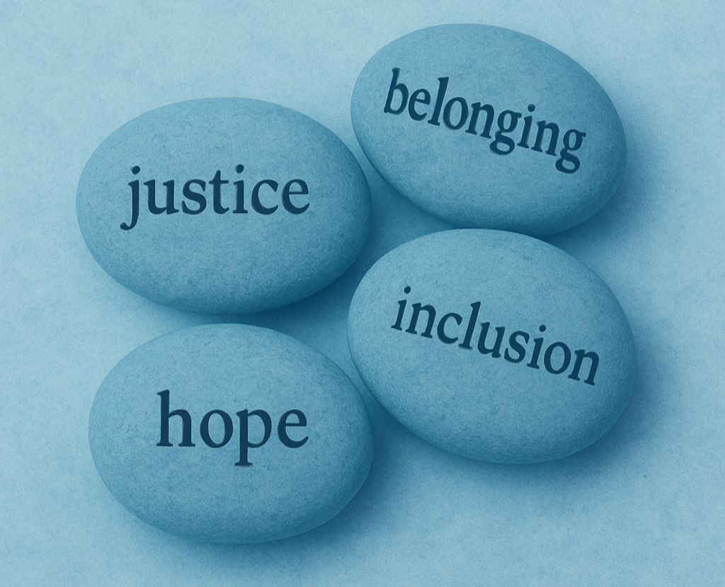 Four blue stones with words "justice," "hope," "belonging," and "inclusion" written on them, arranged on a blue background.