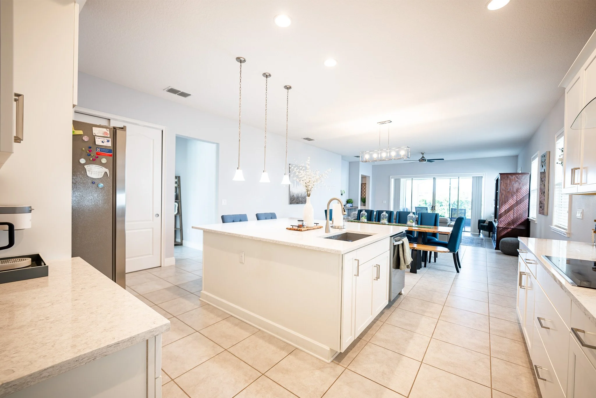 Professional real estate photography showcasing a modern open-concept kitchen in a luxury Central Florida home listing.