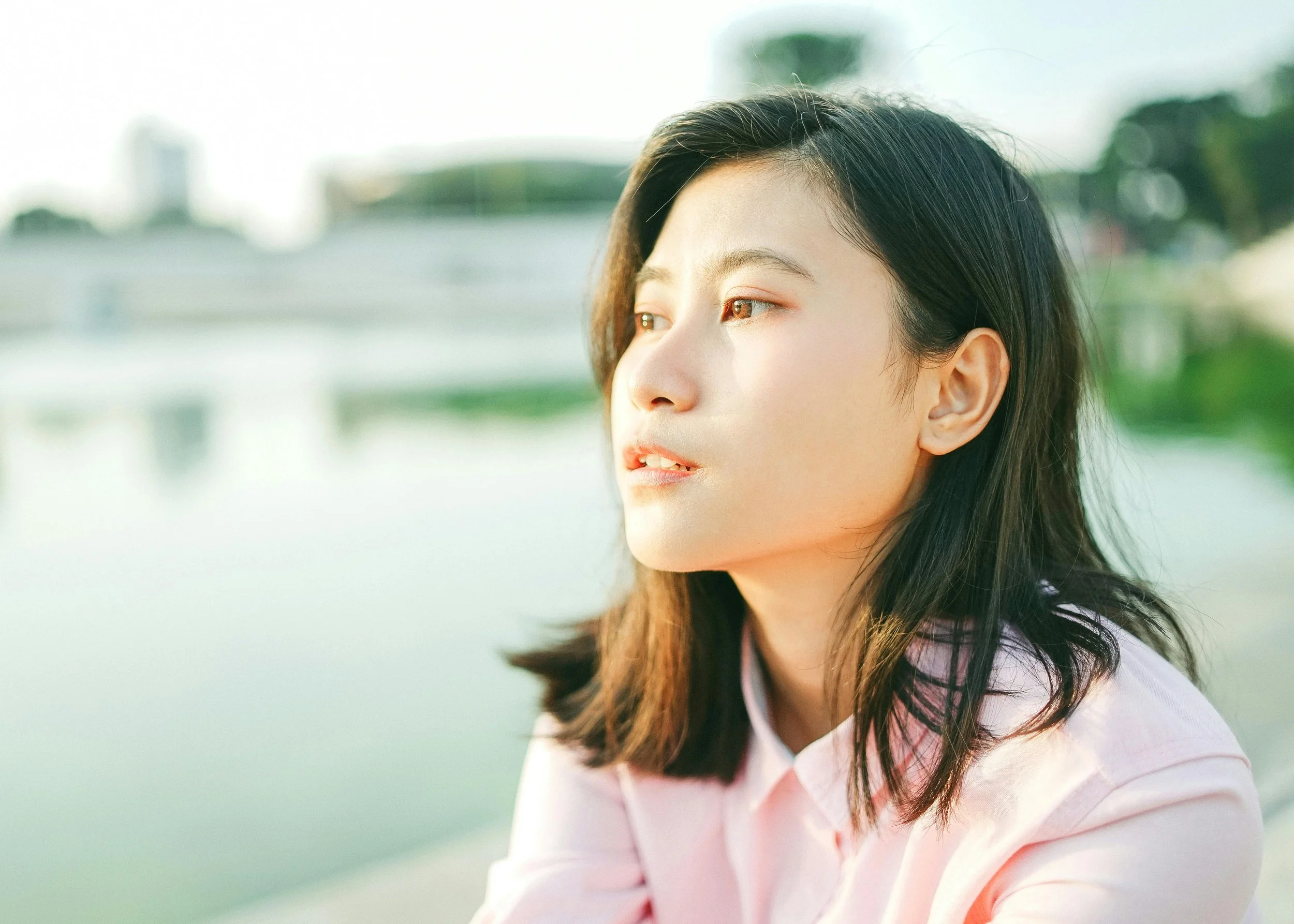 woman sitting by the water reflecting on how to get ahead of high functioning burnout