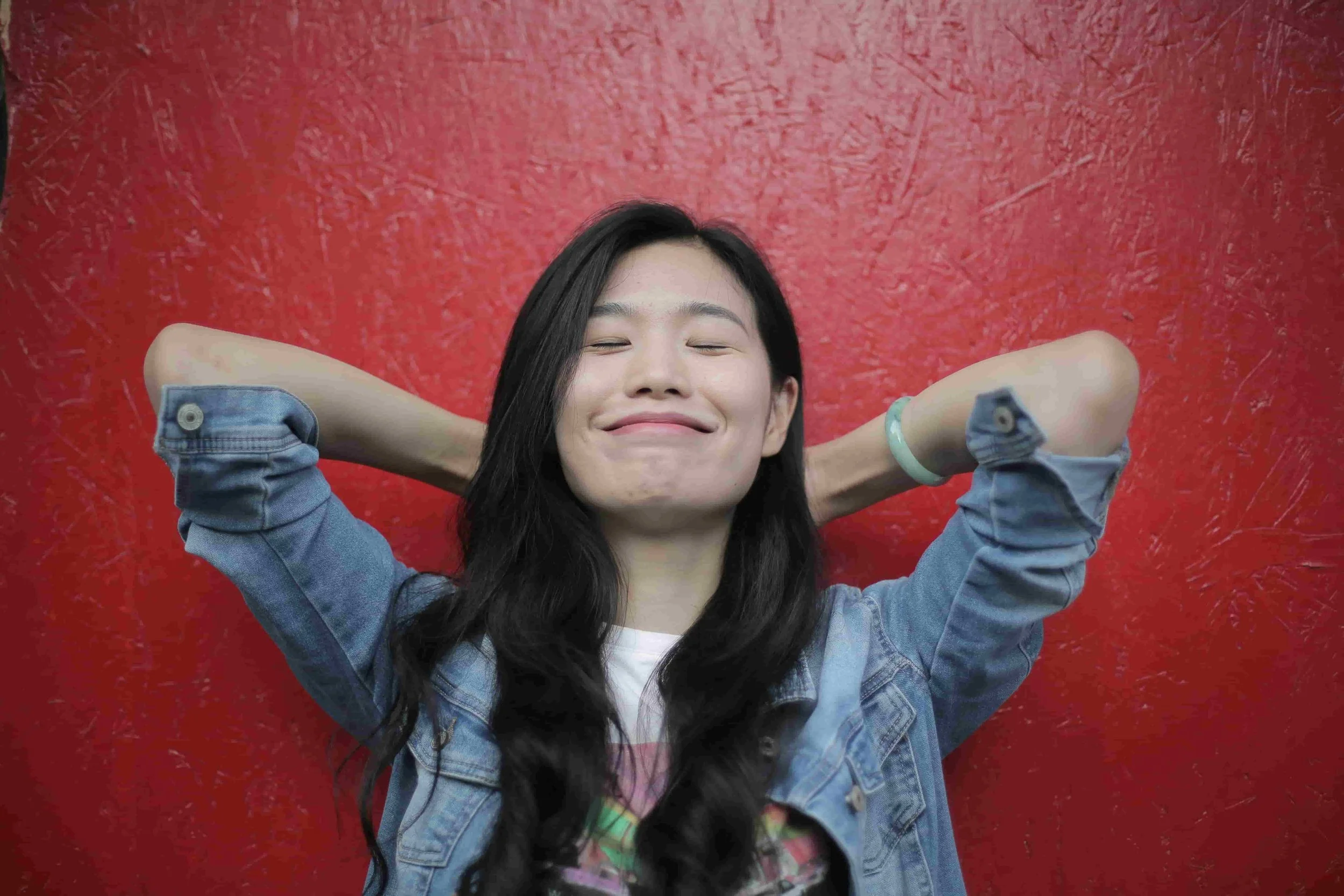 Asian American woman who is relaxed, who has let go, and feels sense of freedom