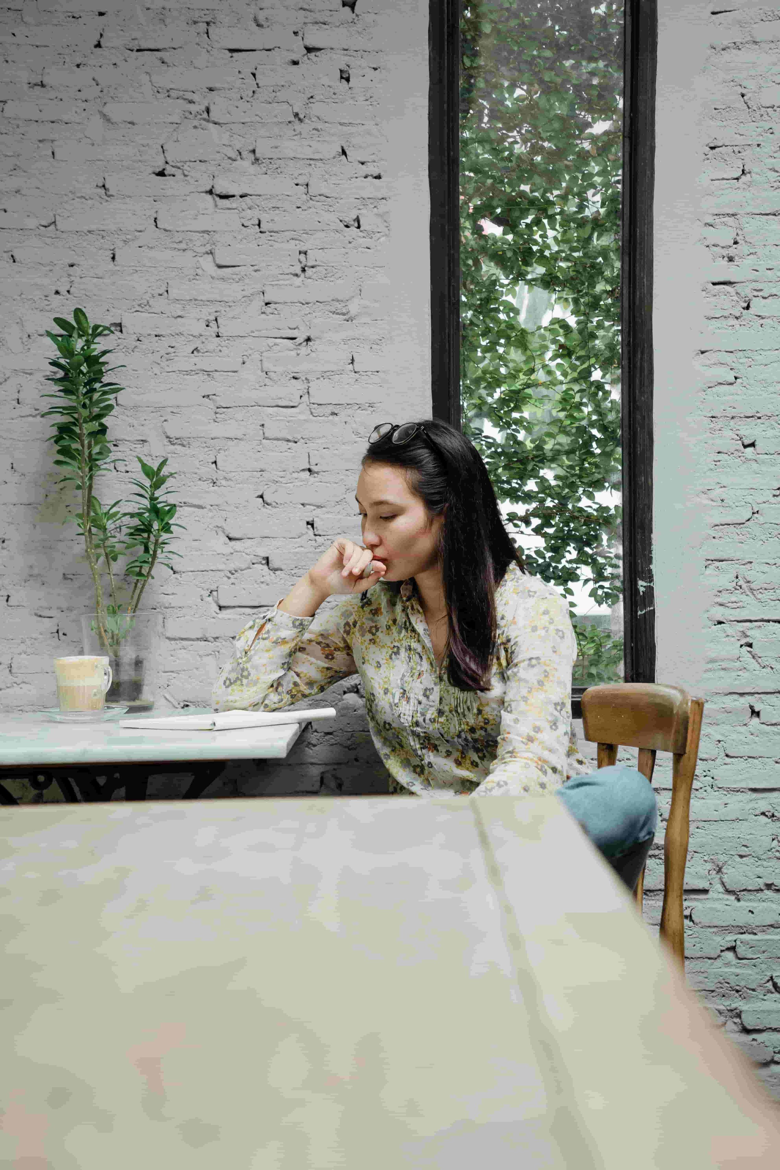 Asian American woman with a fear of falling behind and high functioning anxiety more taking a break and reflecting