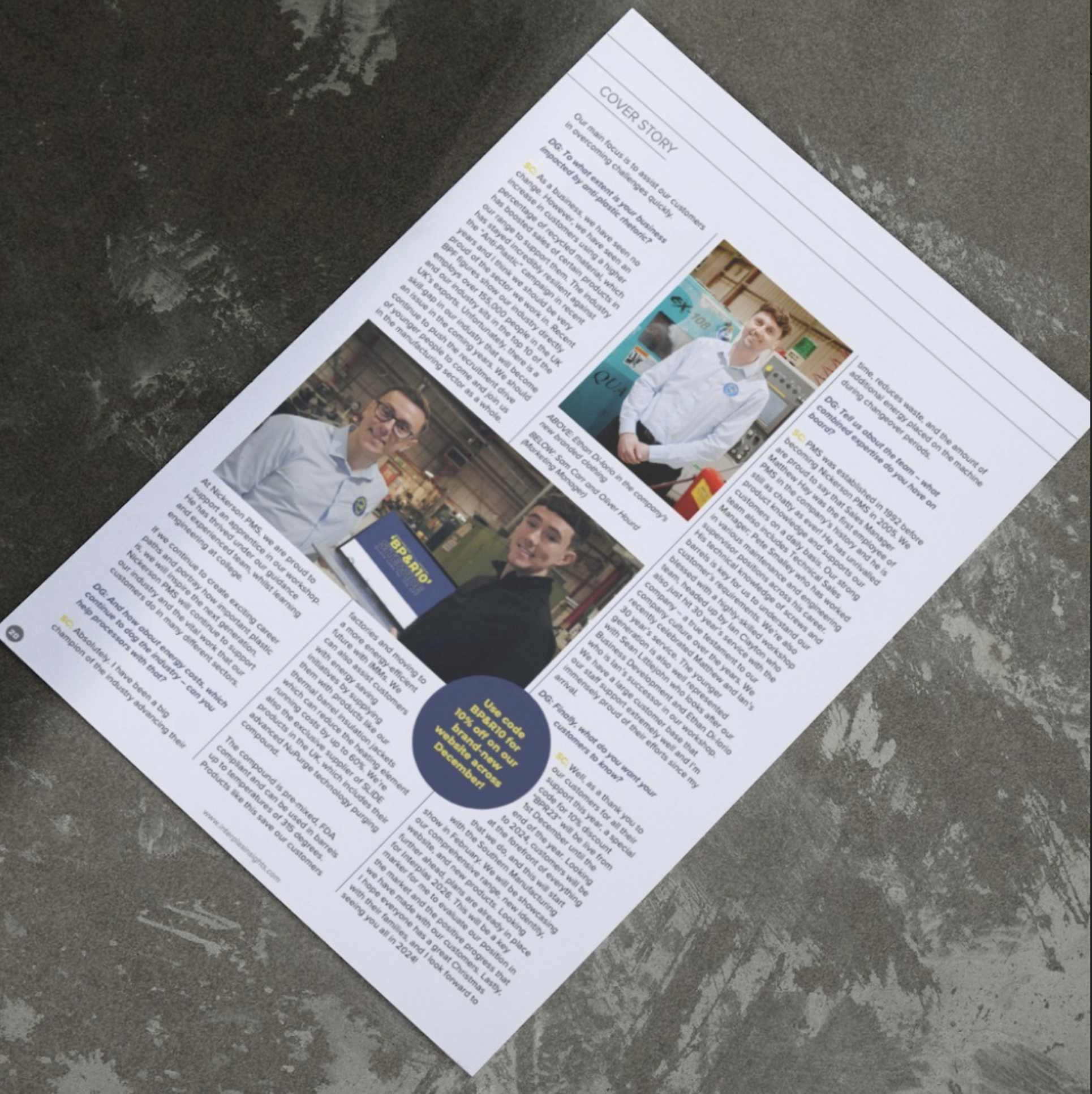 A printed flyer or newsletter on a gray, textured surface. The document contains text, a headline that reads 'Cover Story,' and includes images of two young men, one with glasses and another smiling, both dressed in casual or work attire. The content