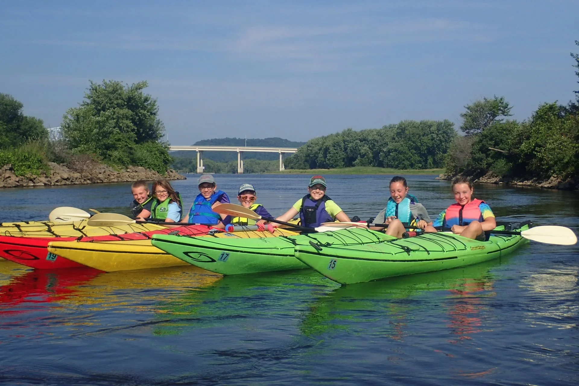 young kayakers near a bridge in Red Wing