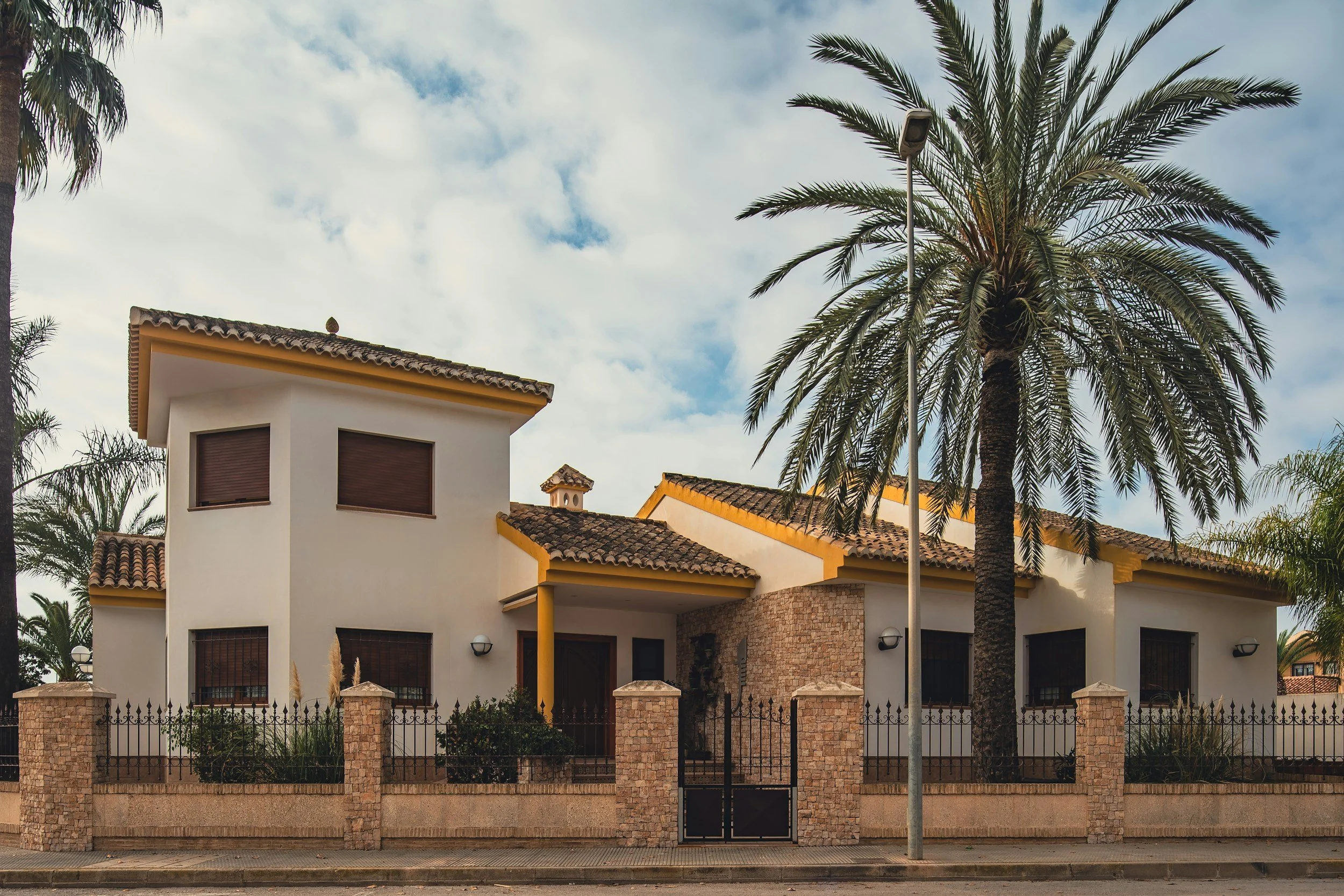 Spanish villa with palm tree representing a long term rental property