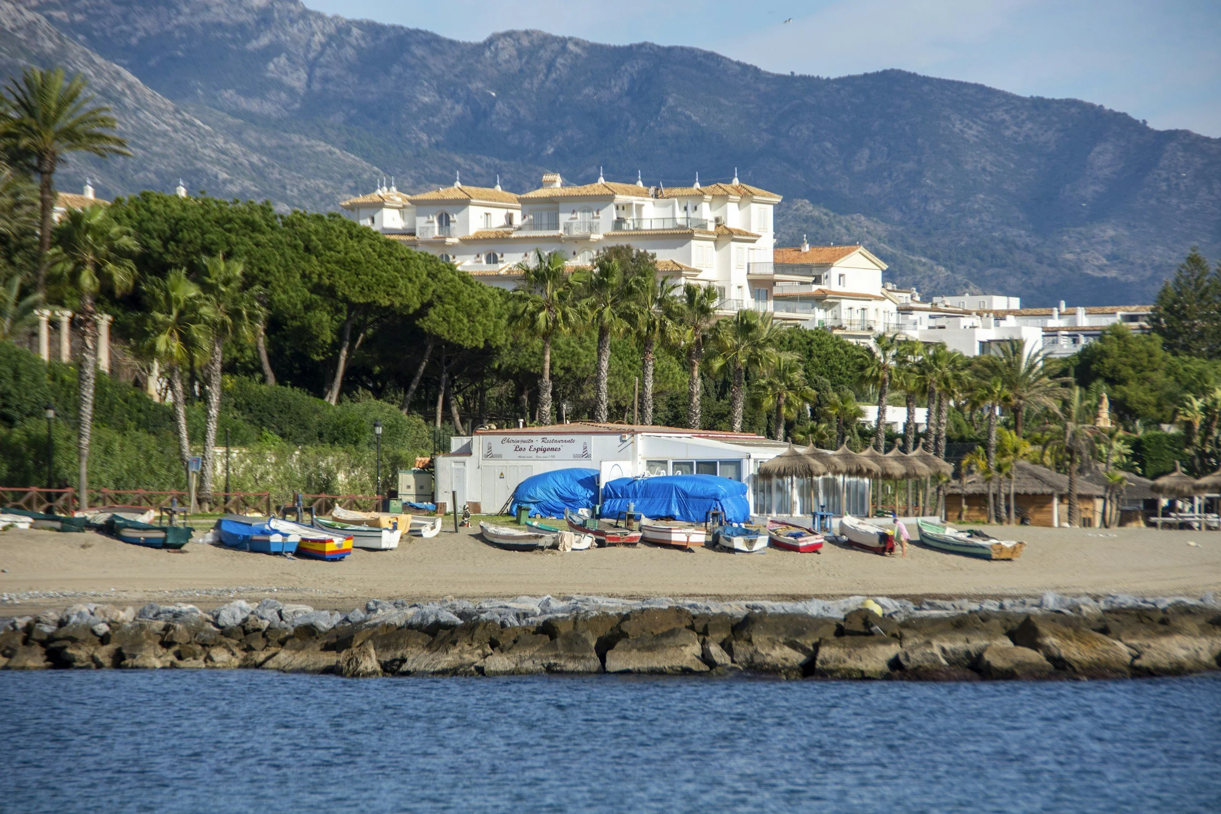 Luxury coastal properties in Marbella with mountain backdrop