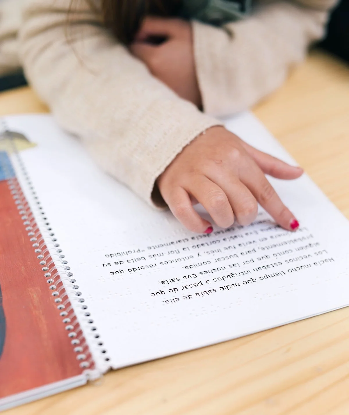 Student reading Spanish-language materials during a tutoring lesson with Toni Ferrer Studio