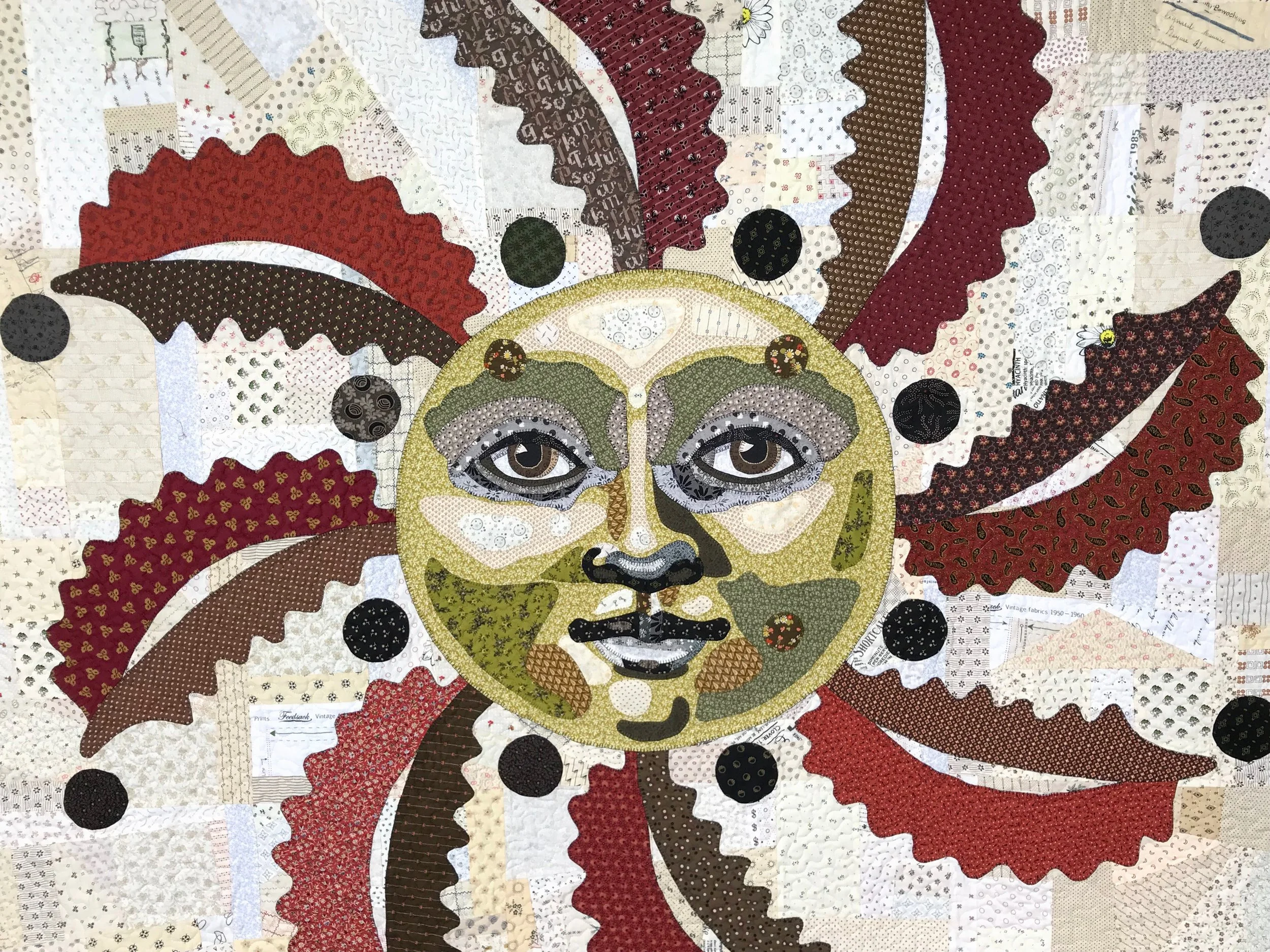 sun art quilt wall hanging featuring applique with a blanket stitch