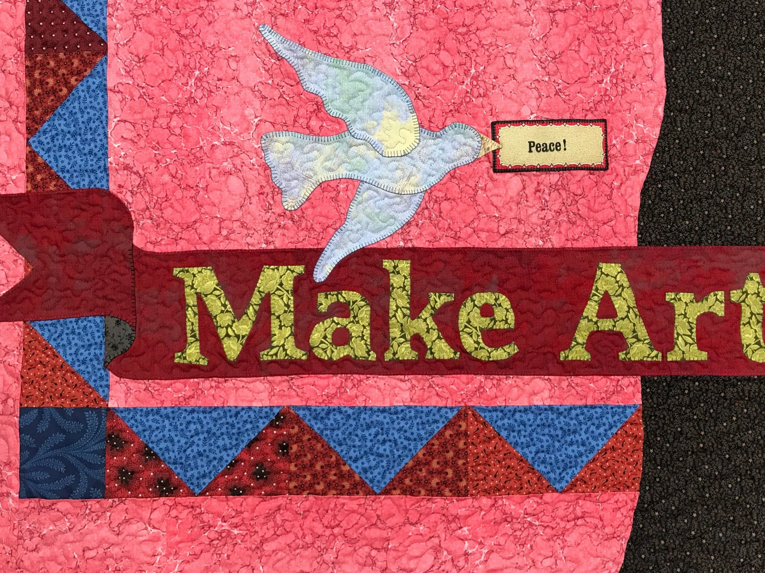 quilted wall hanging with peace dove