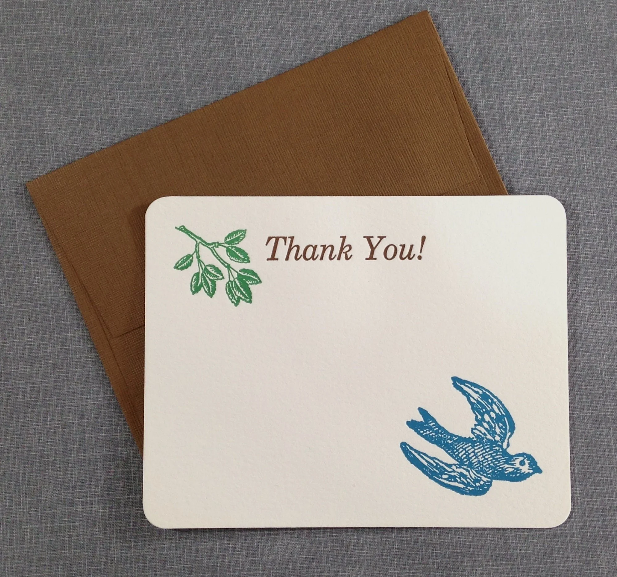 bluebird flying on a letterpress card printed on cotton paper