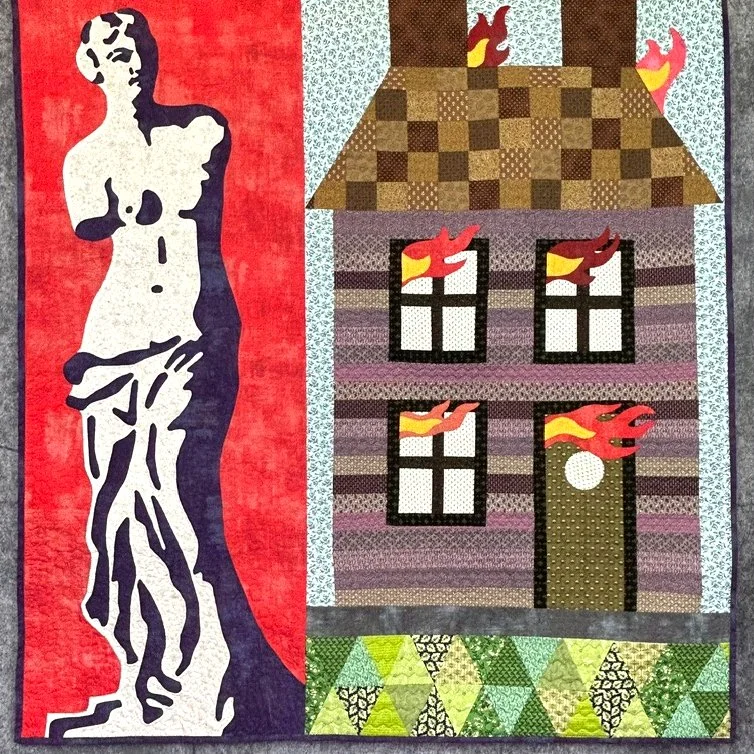 folk art quilt featuring Venus figure in calico with burning house applique