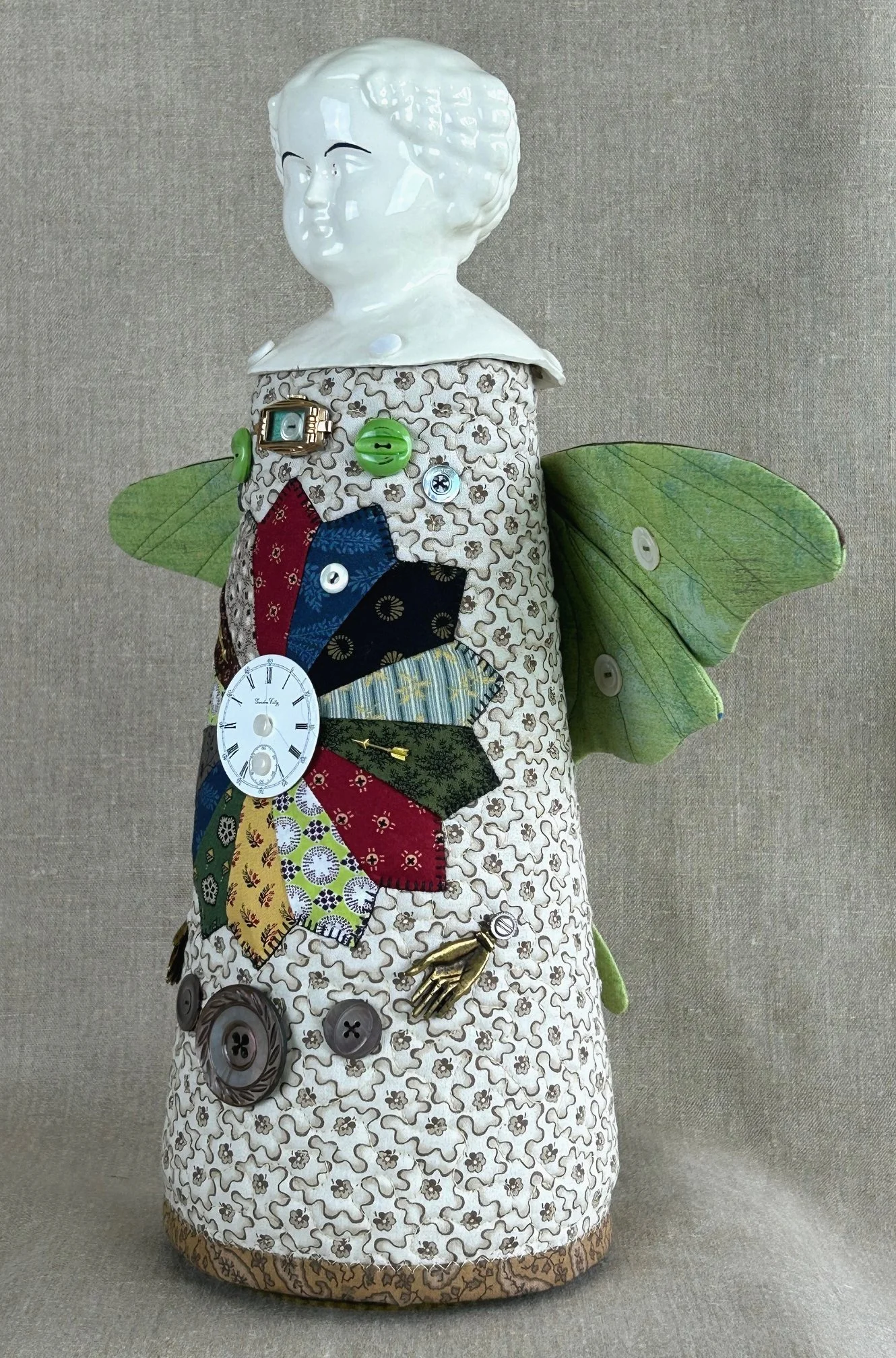 side view of spirit totem doll heavily decorated with textile art