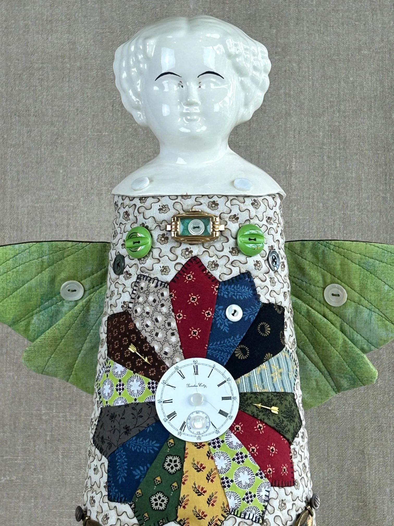 detail of folk art assemblage doll featuring porcelain head