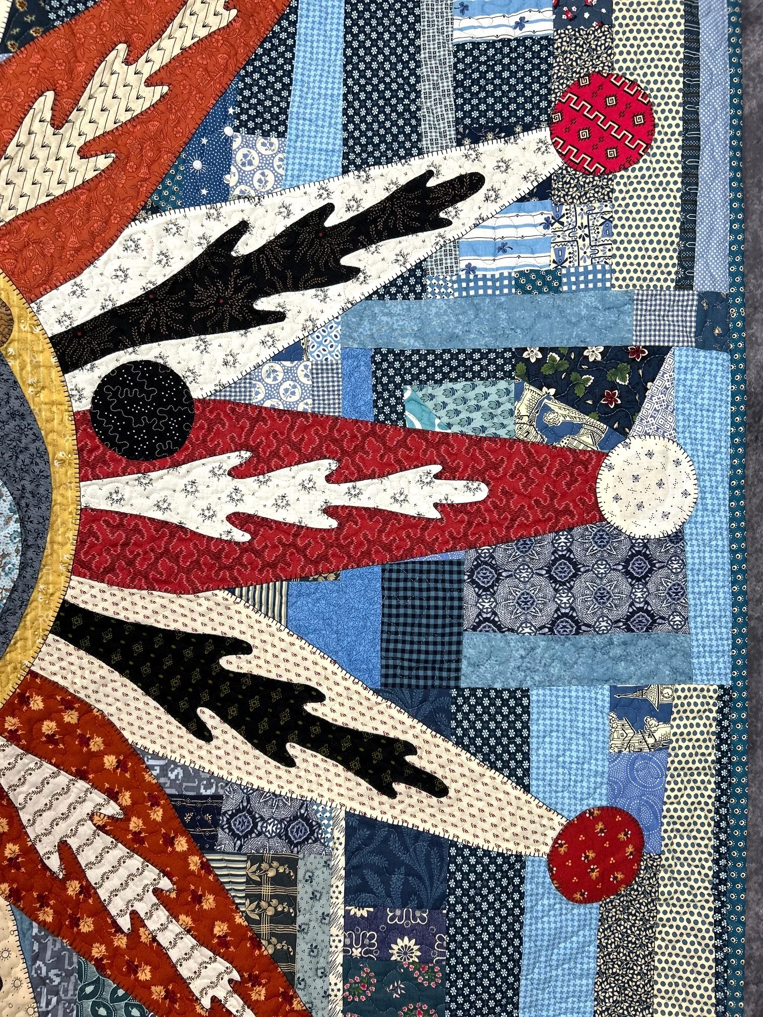 detail of folk art sun quilt featuring the appliqued rays