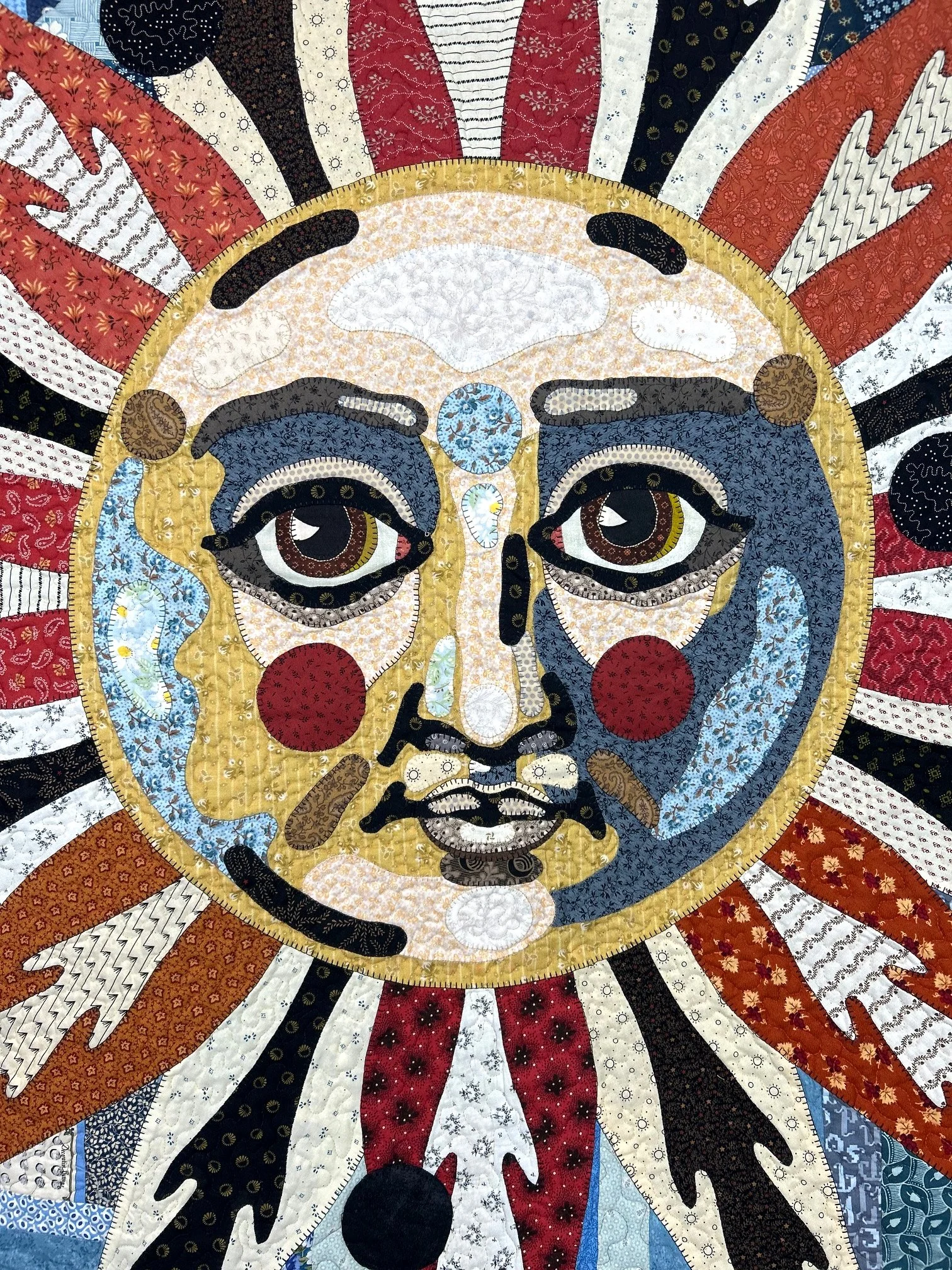 pictorial folk art wall hanging of a medieval sun