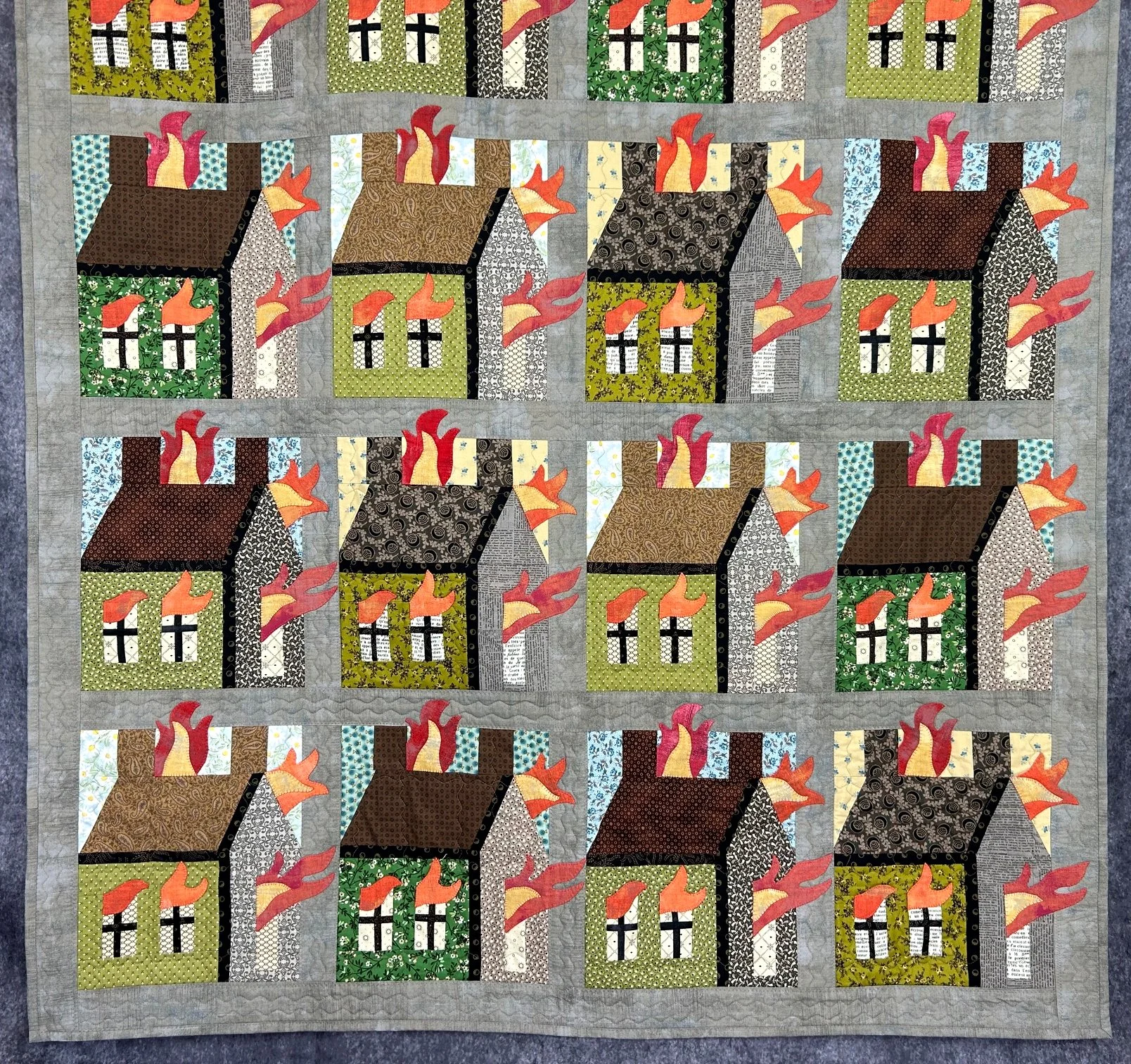 fiber art quilt using 19th century reproduction fabrics and applique flames on a schoolhouse quilt