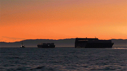 Ships sailing on the water during a sunset featuring Deforge Maritime company