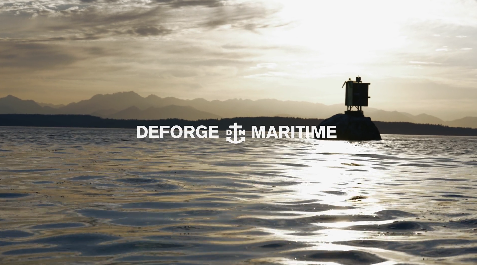 A maritime navigation tower on a rock in calm water during sunset with a mountain range in the background and the text 'DeForge Maritime' overlaid.