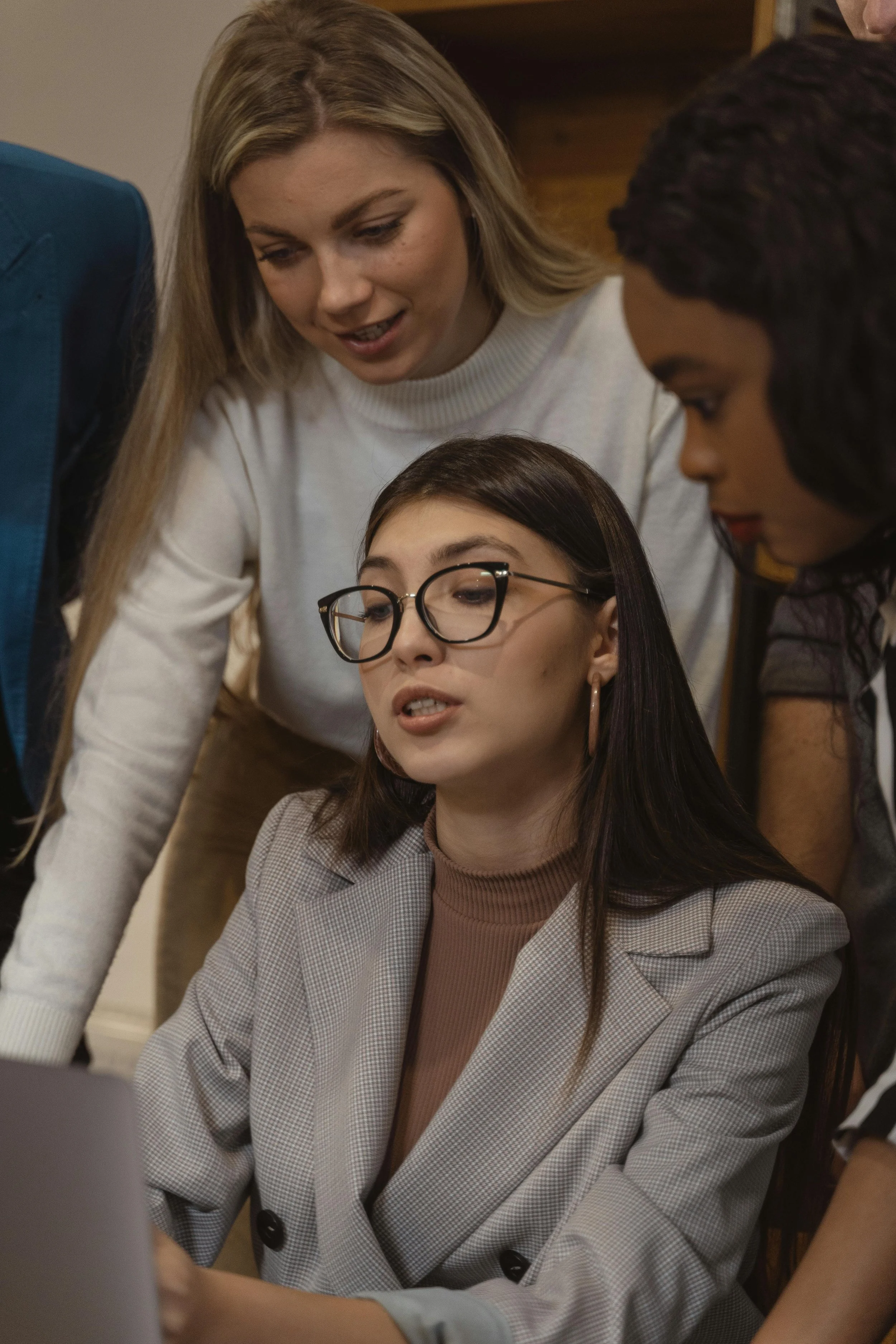 a person explaining to others in front of a laptop