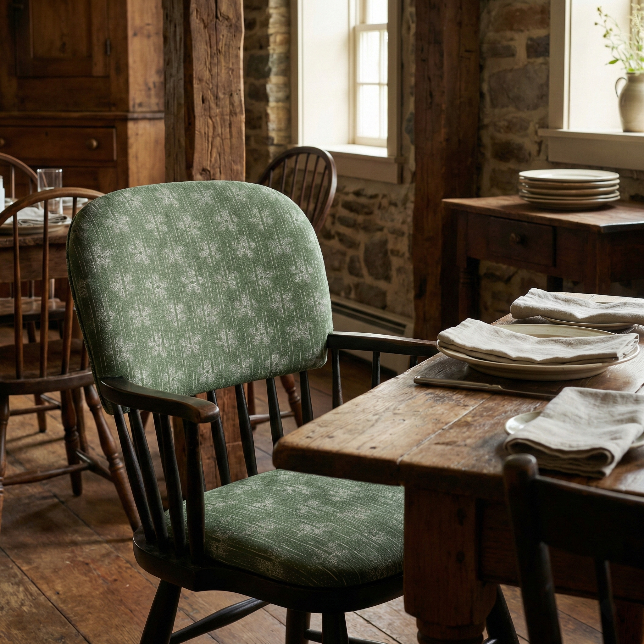 Cozy luxury restaurant interior featuring Cora Dillweed modernist folk fabric as chair cushions, highlighting the 'fresh traditional' aesthetic valued by high-end designers.