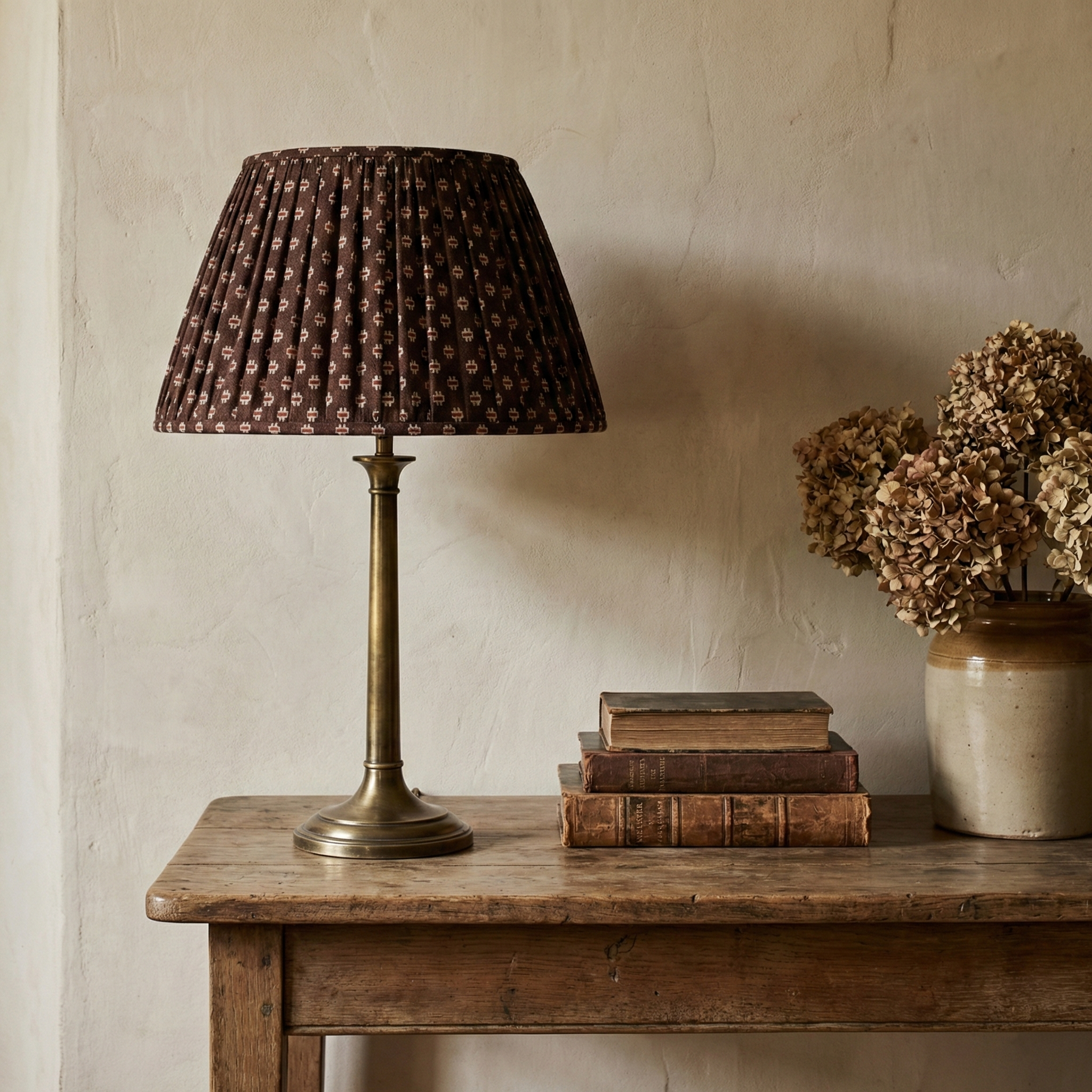 Bespoke Scarab Loam lampshade styled on an antique lamp base, serving as a poetic and historically anchored decorative element.