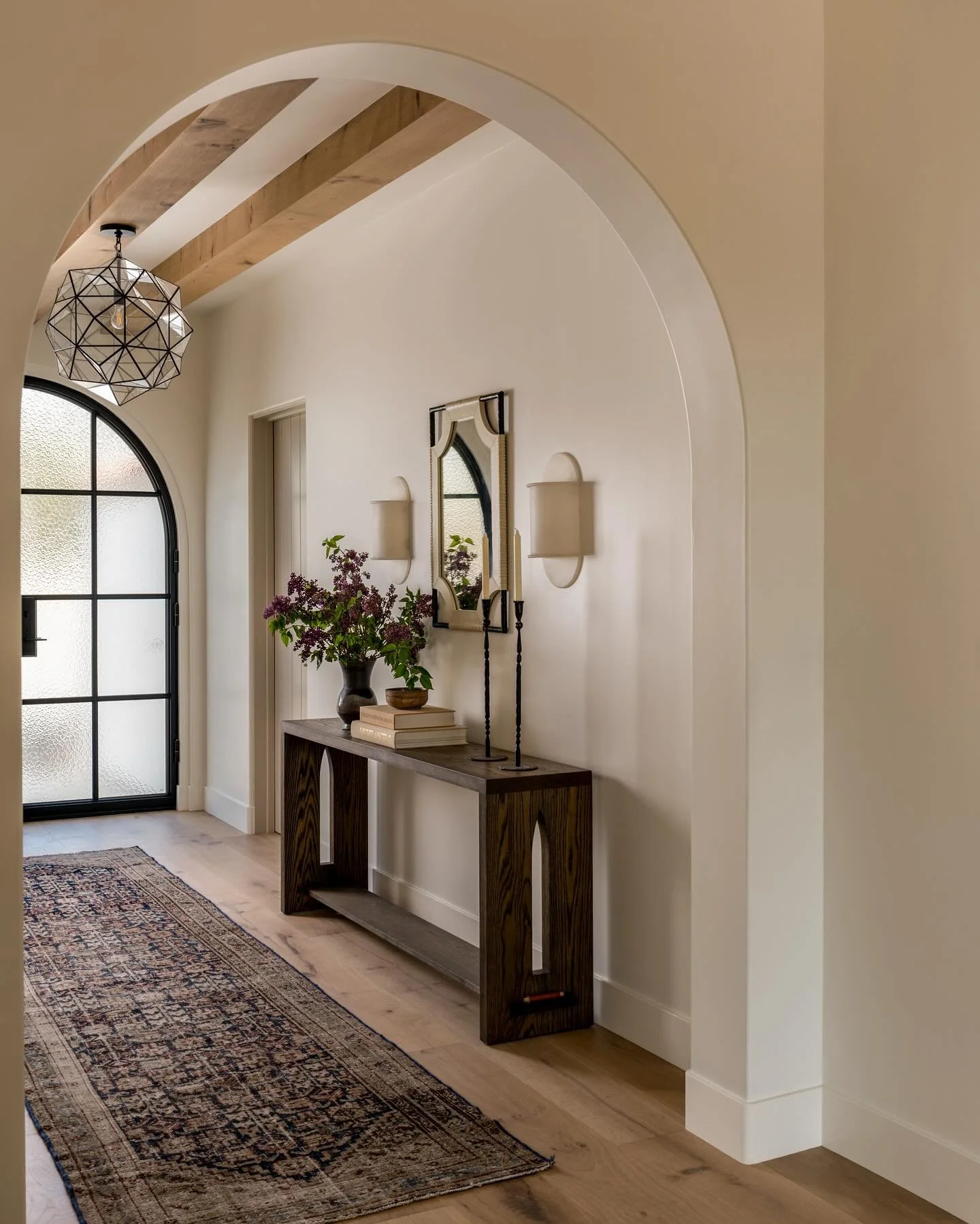 Quiet entryway moments from our Canyon project. 

Your first steps inside from the terracotta clad courtyard will greet you with warmth and welcome. Overhead glass lighting, alabaster sconces, and a mix of custom furniture paired with the most perfec