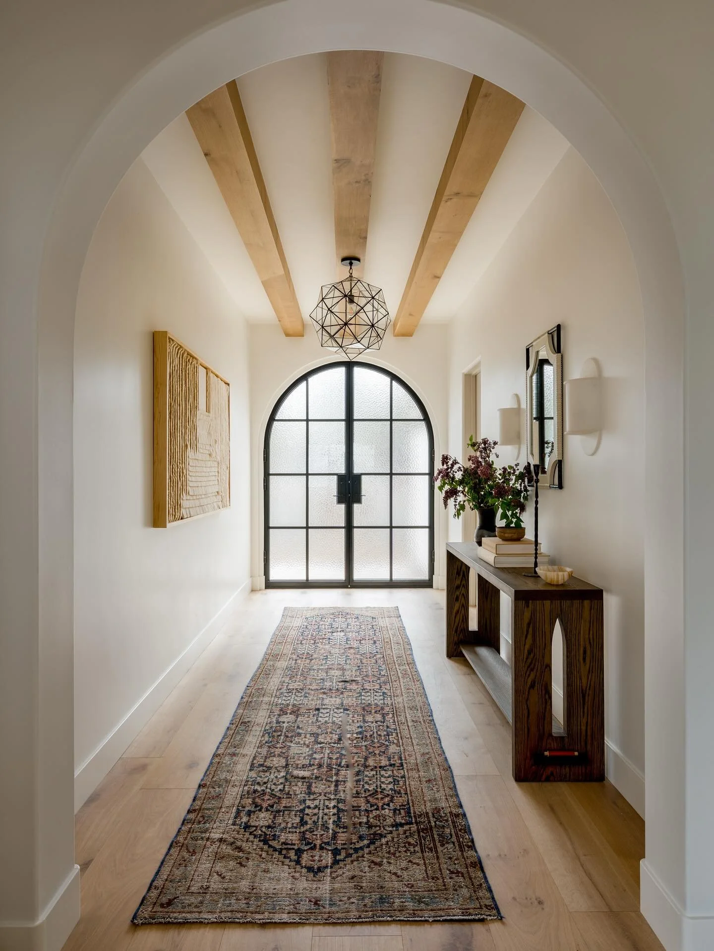 More of our entry at Canyon- a soft welcome into the Spanish Modern home featuring lighting by @lavivahome and a hand-crafted textile from @caralarga_mx 💫

Design/Styling: @anaberdesign 
Architecture: @t7architecture 
📷: @charlotteleaphotography 

