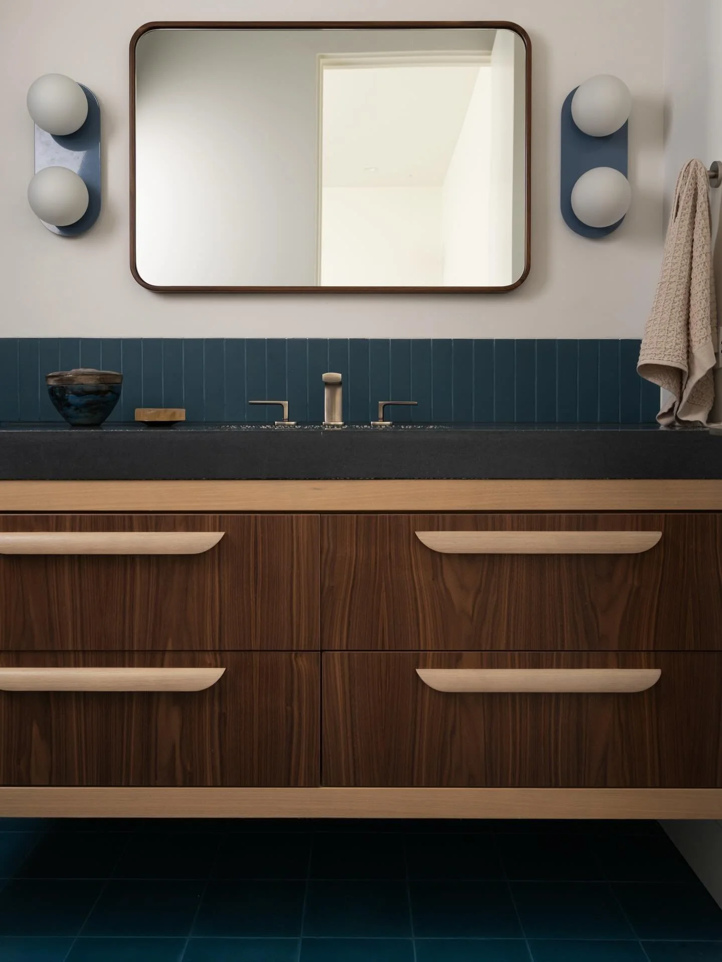 The blue bathroom at our #wilstone project. We kept the tile palette simple and monochrome using both a cement tile and ceramic tile from @zia_tile. For the vanity, we explored using two different tones of wood for a fresh and playful approach. 

Arc