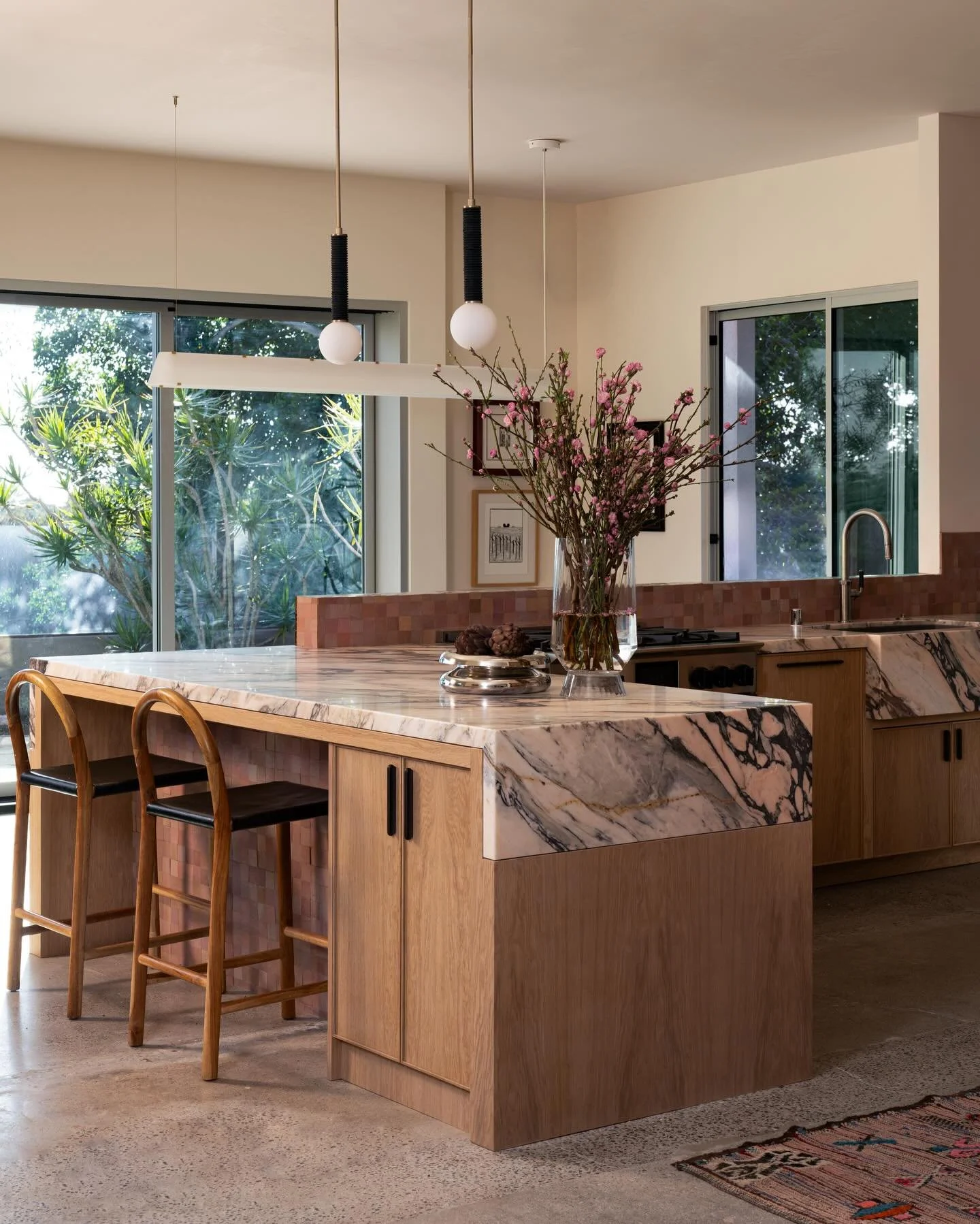Same view, but not really. 

Swipe to see where this renovation started 👉🏻

We paired the burgundy range (client&rsquo;s first selection for the project, with an abundance of pink: pink zellige tile from @zia_tile to be exact. The burgundy hue and 
