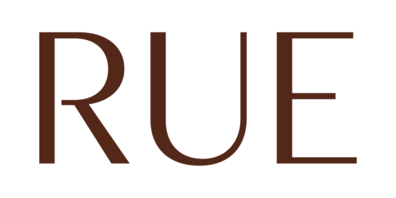 The word 'RUE' written in bold, dark brown letters on a black background.