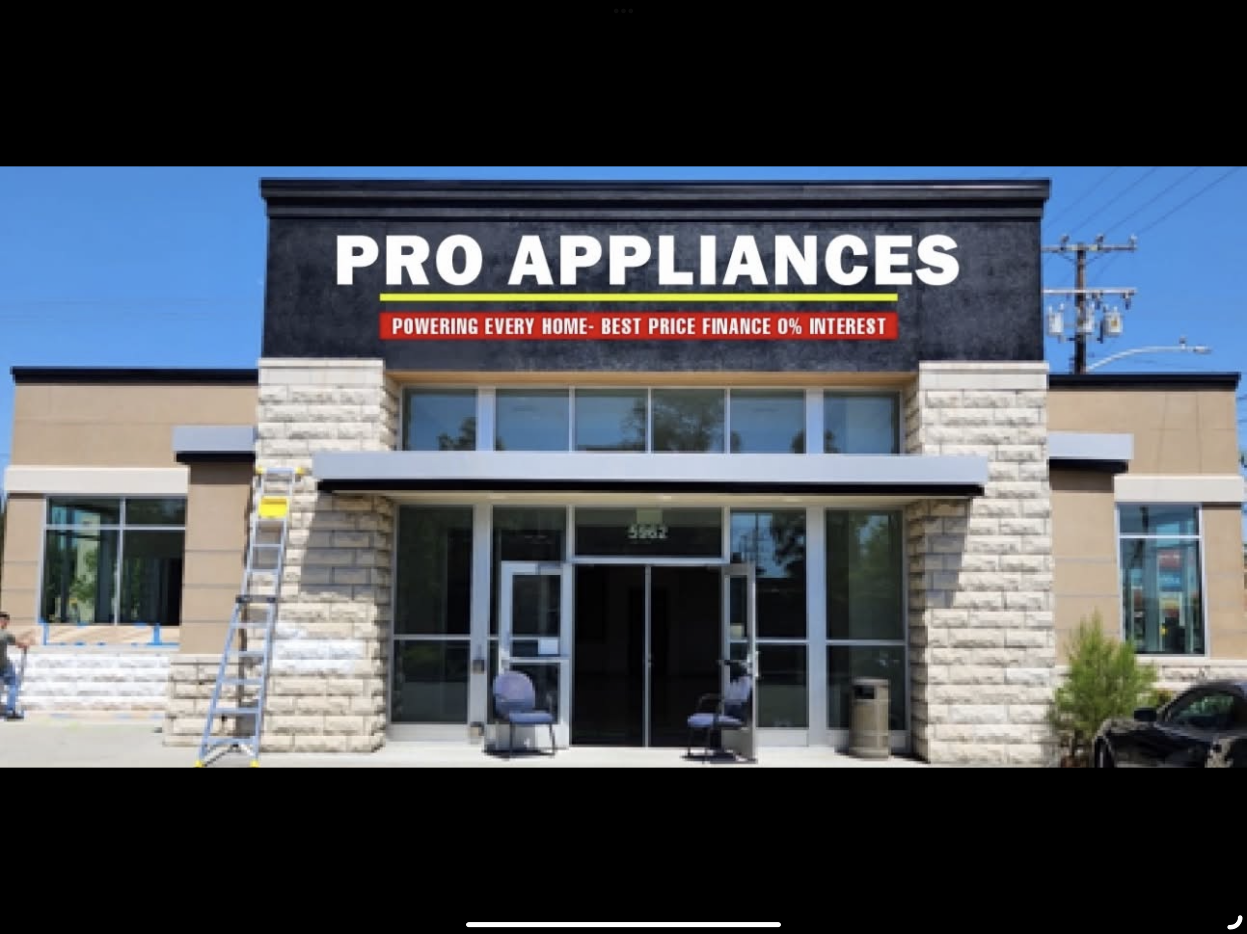 Front of a commercial building with a sign reading 'Pro Appliances' and a red banner with white text beneath it.