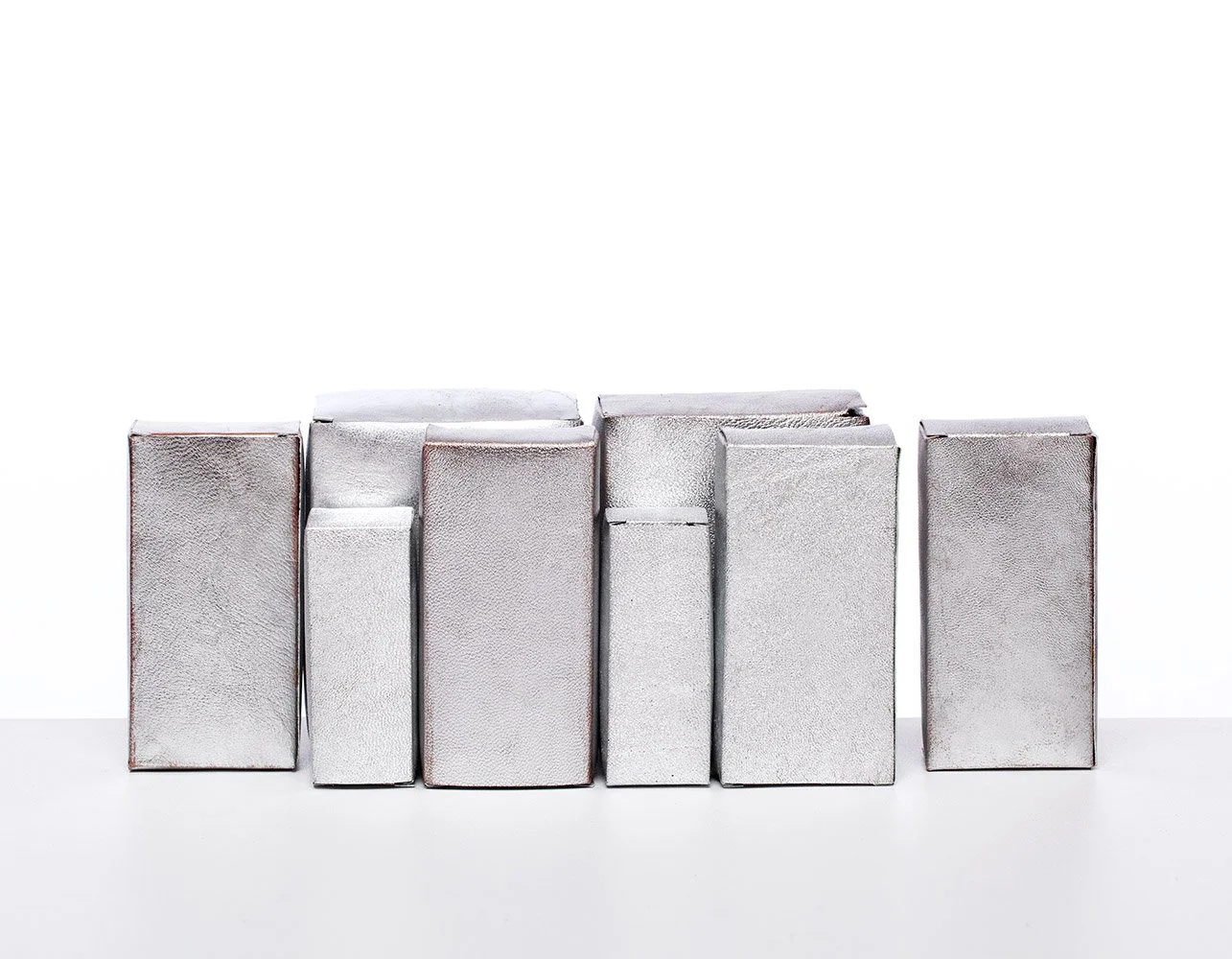 Cart No 12 New Jining Grey Metropolis, 2015, leather mounted on white wooden shelf, 50x26x13.5 cm