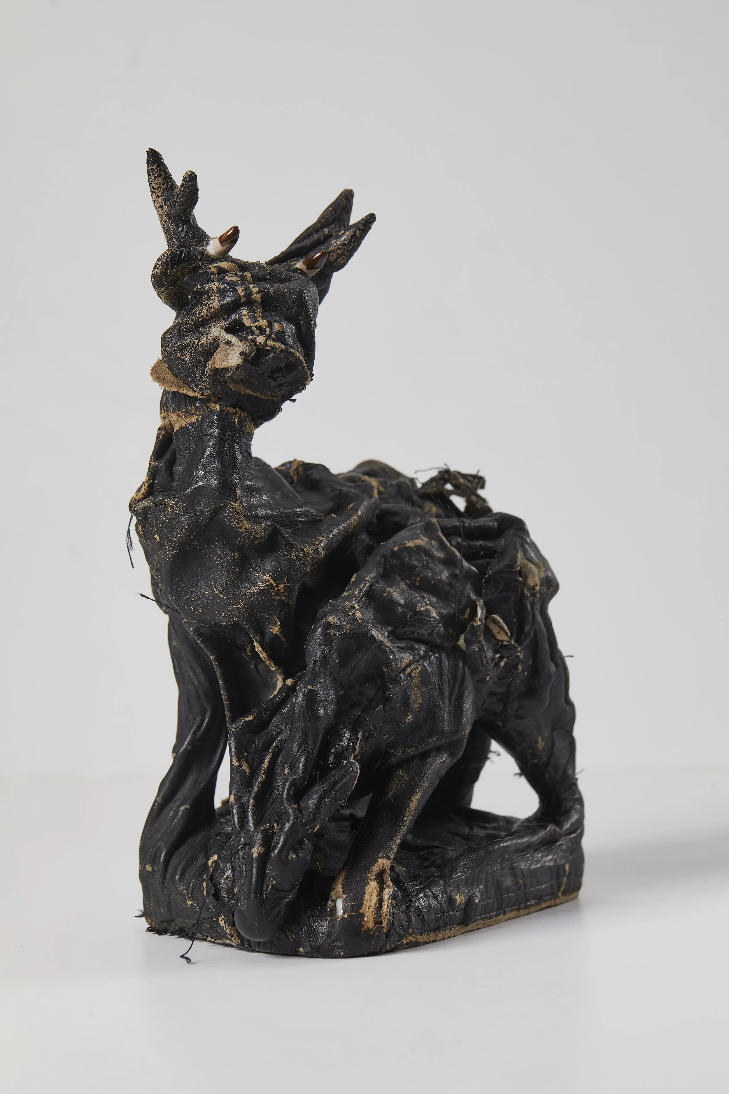 Pair of Deer, 2025, recycled leather over vintage porcelain statue, 18x26.4x12.3 cm