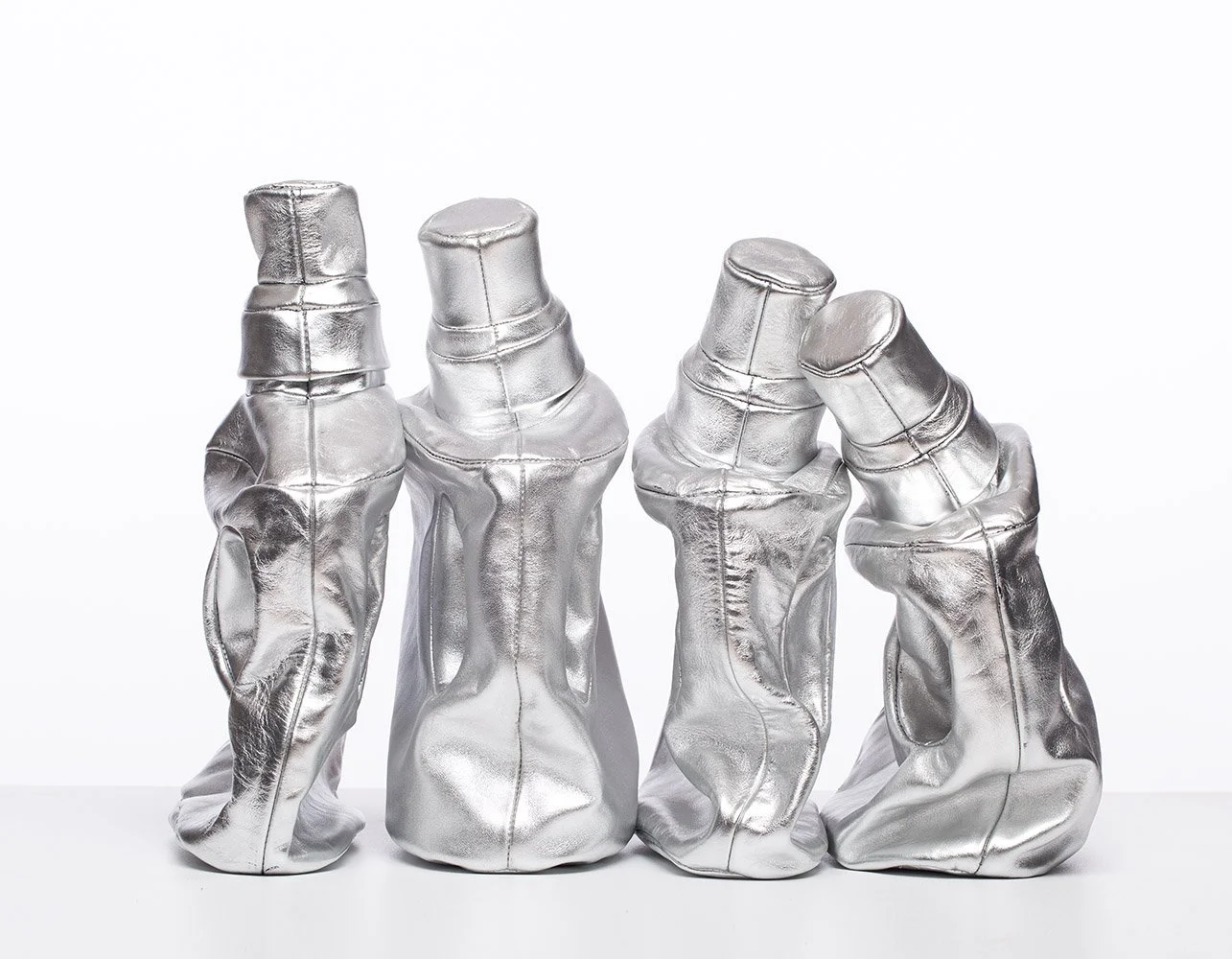 Cart No 11 Four Steel Taurus, 2015, leather mounted on white wooden shelf, 50x35x23 cm