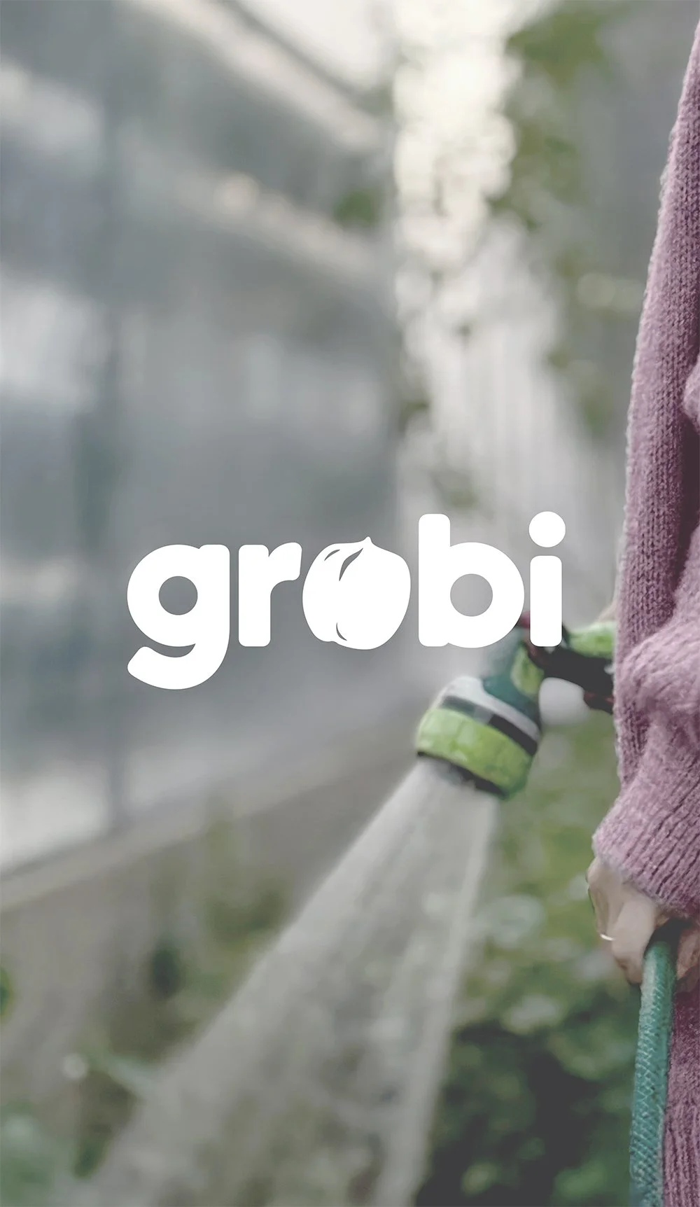 Person watering plants in a garden with the 'grobi' logo overlay.