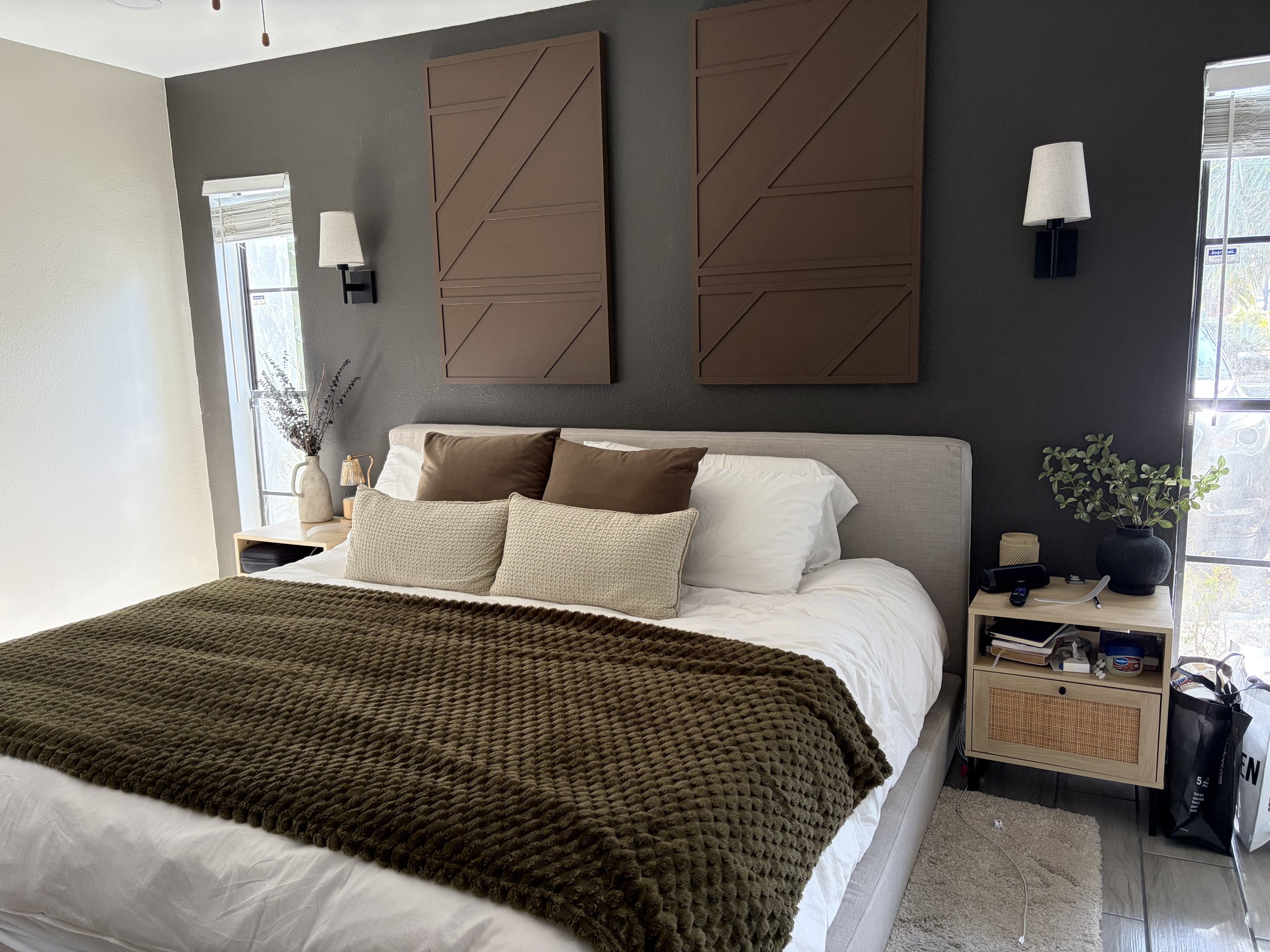 A cozy, freshly made bed with fluffy pillows and beautiful background, calm, warm