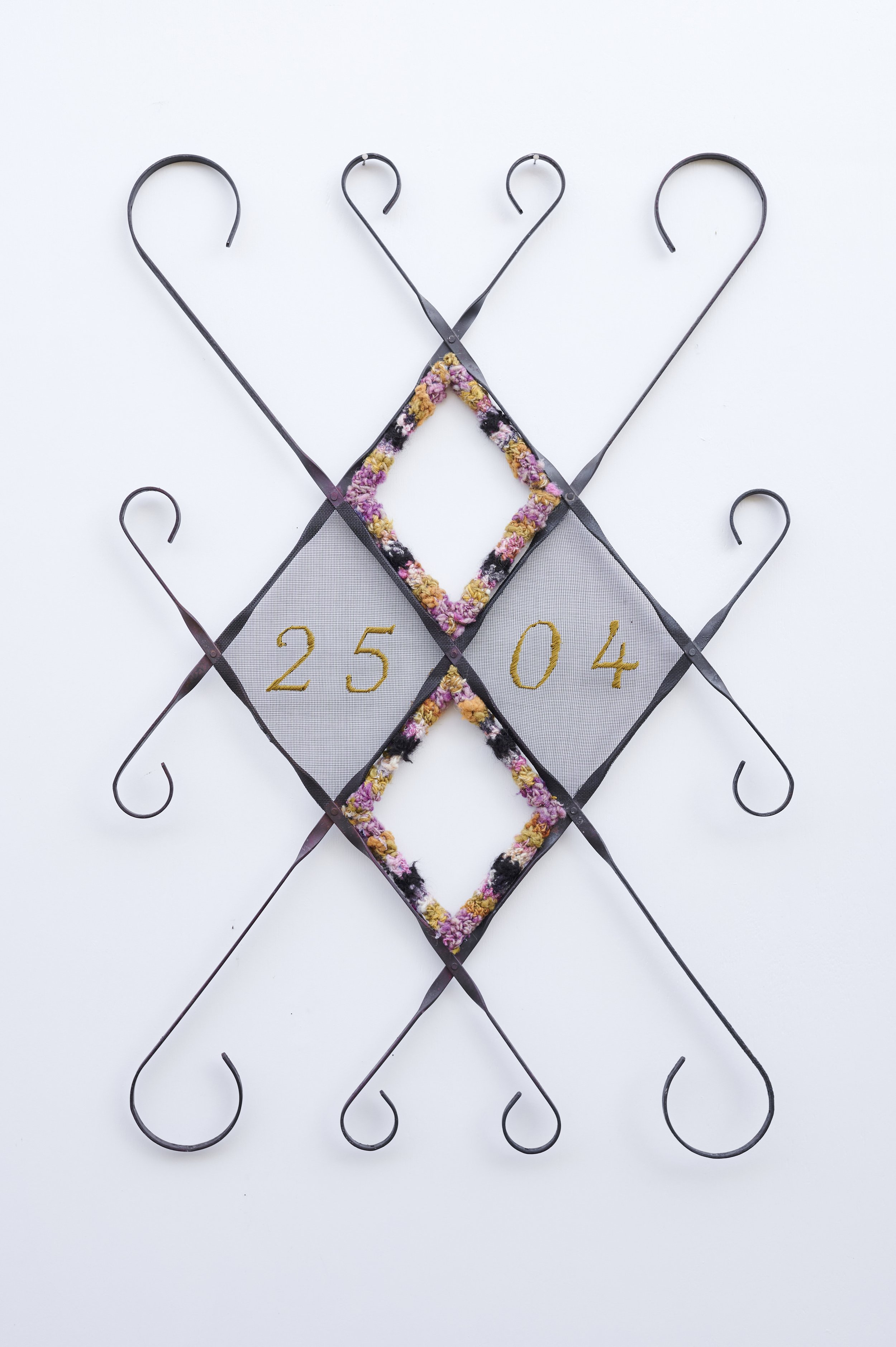 Homecoming, 2026. Salvaged screen door frame, screen, heirloom textile, embroidery floss