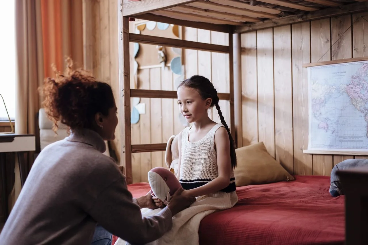 A mother discussing something with her daughter