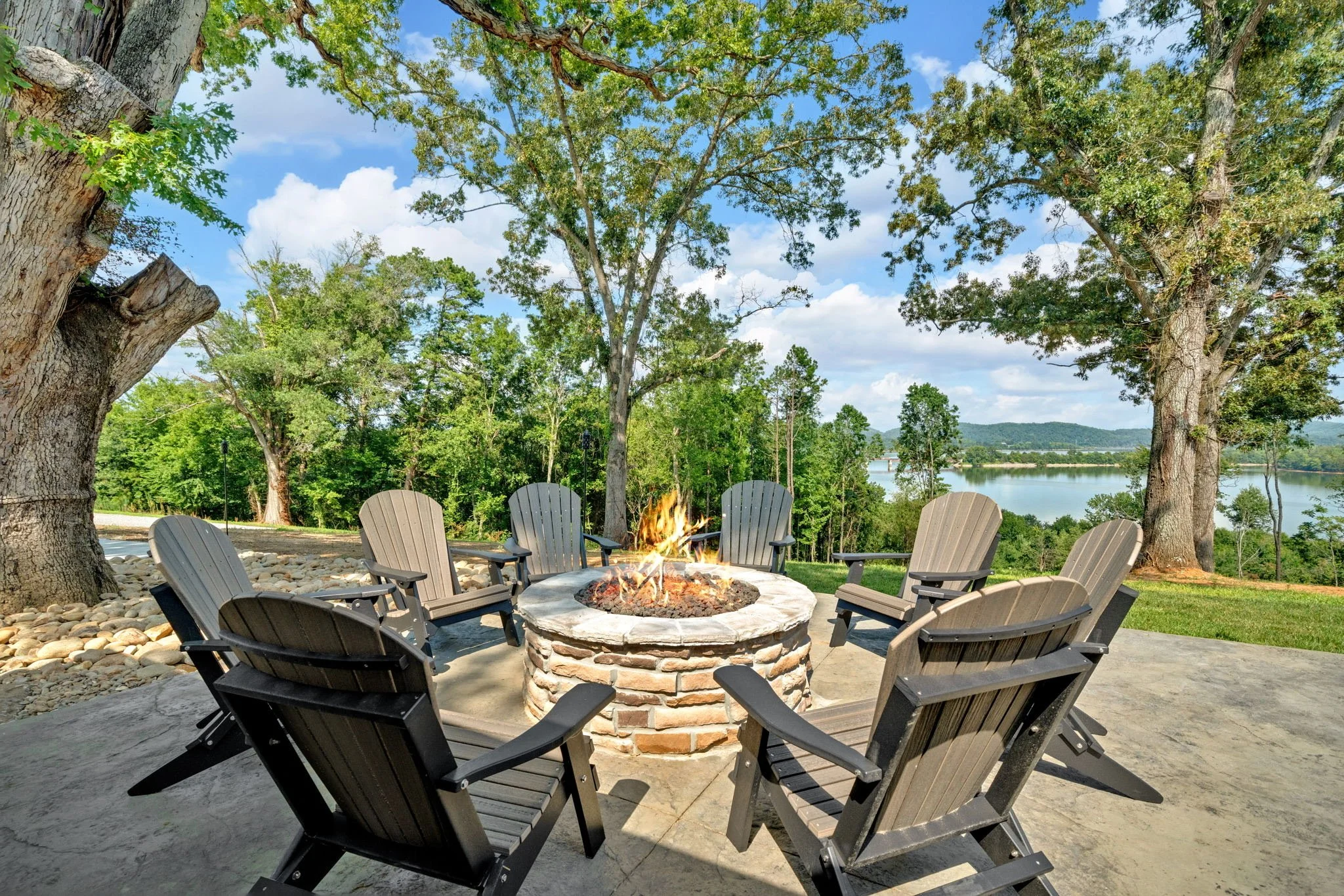 Adirondack chairs adorn the stone fire pit, perfect for overlooking lake or gathering underneath the stars.