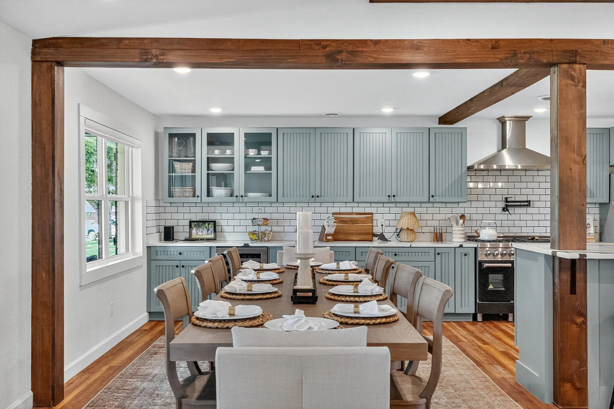 Dining room with a large wooden table set for ten.