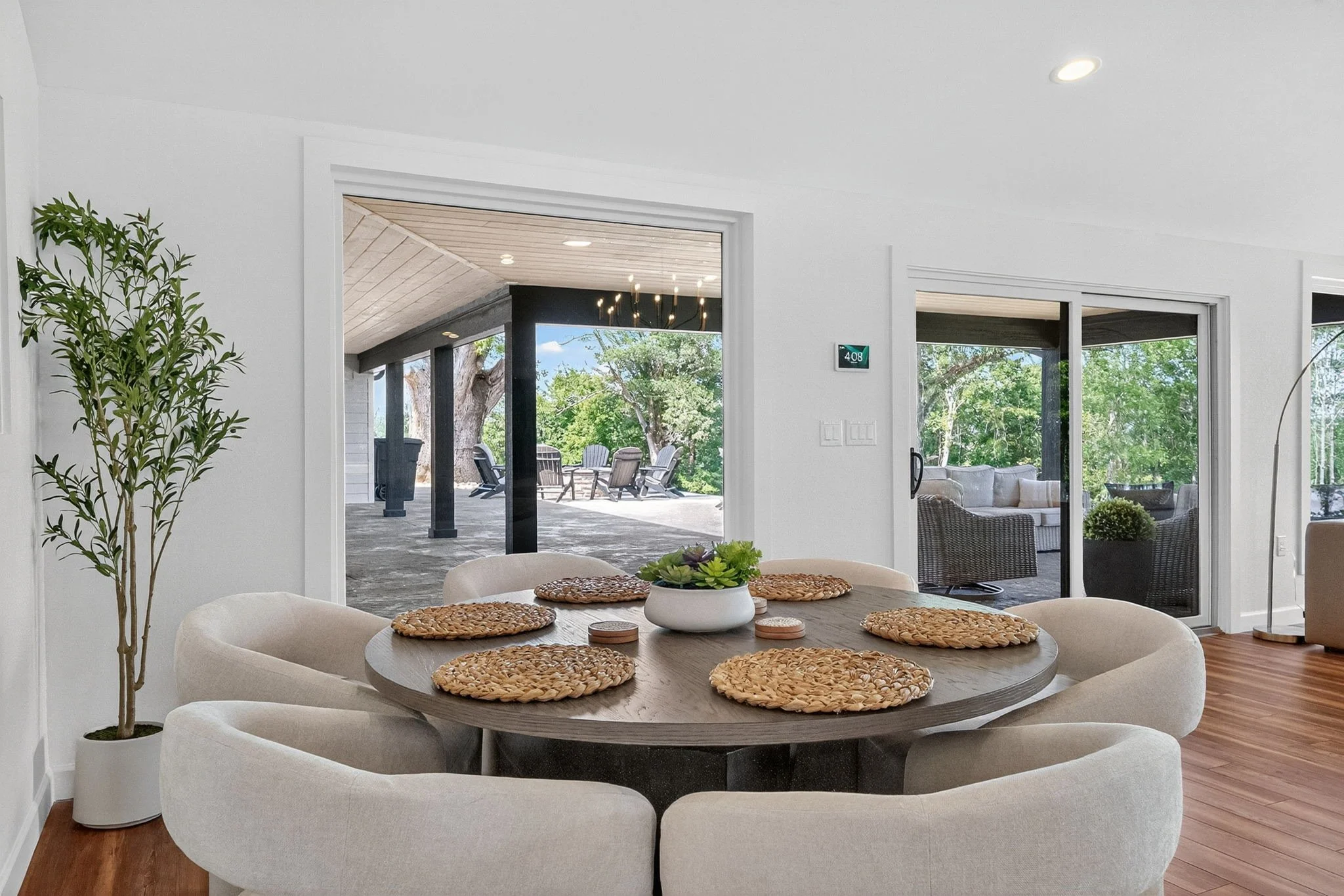 Great room with seating inlcuding six chairs, perfect for meals or family games. The large sliding glass doors lead to the outdoor patio overlooking the majestic lake and wildlife reserve.