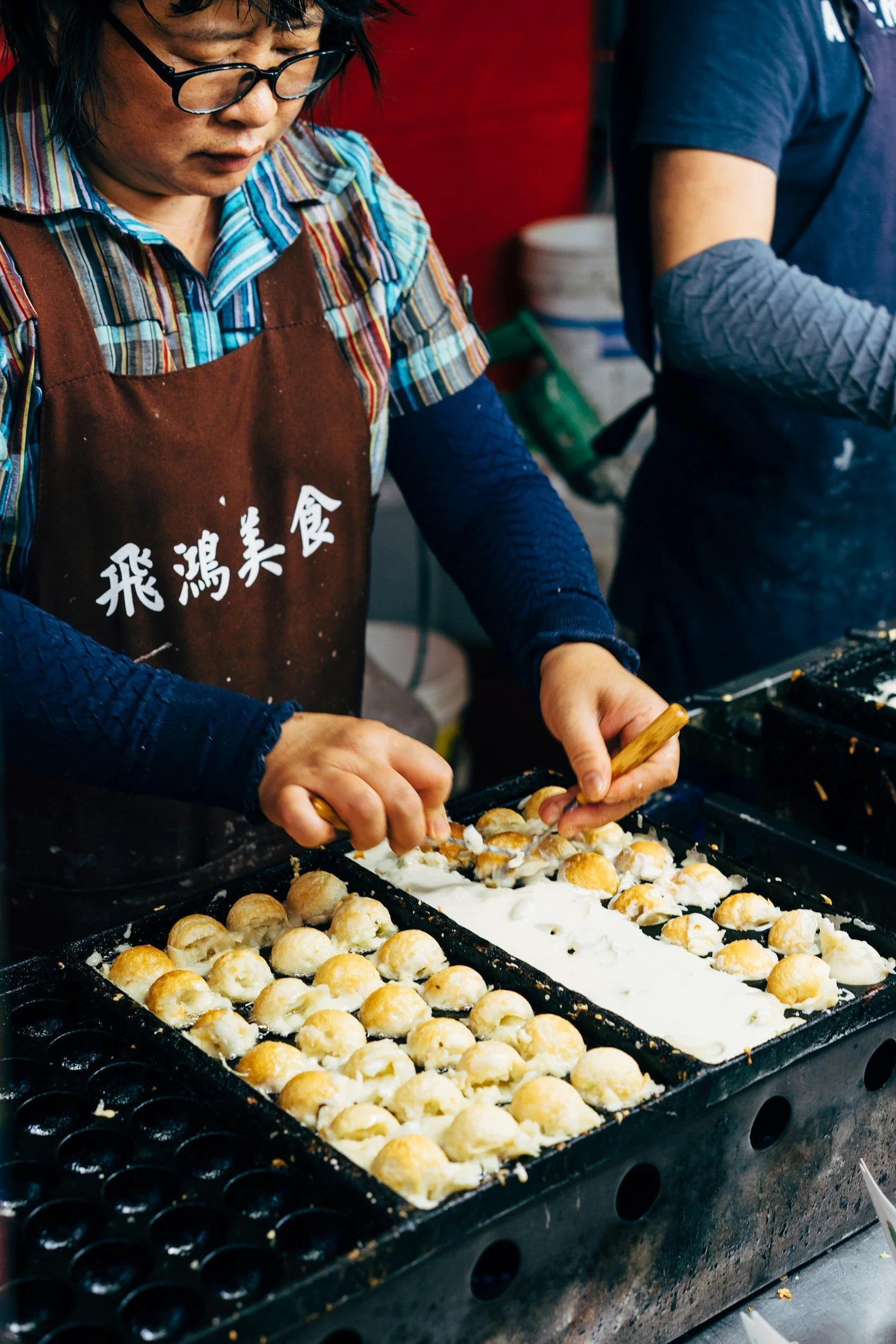 Person making takoyaki