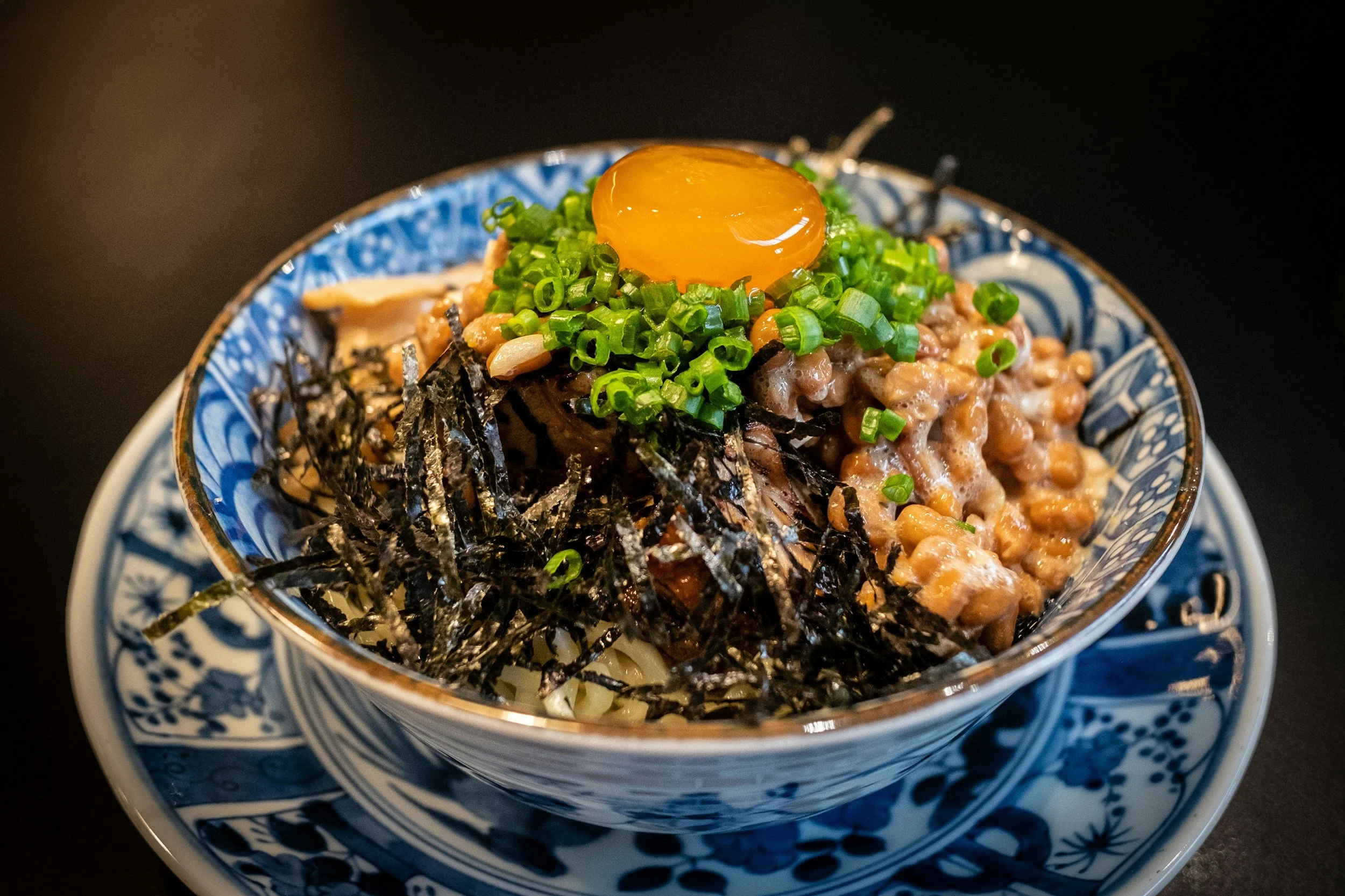 Rice bowl topped with natto, seaweed and an egg