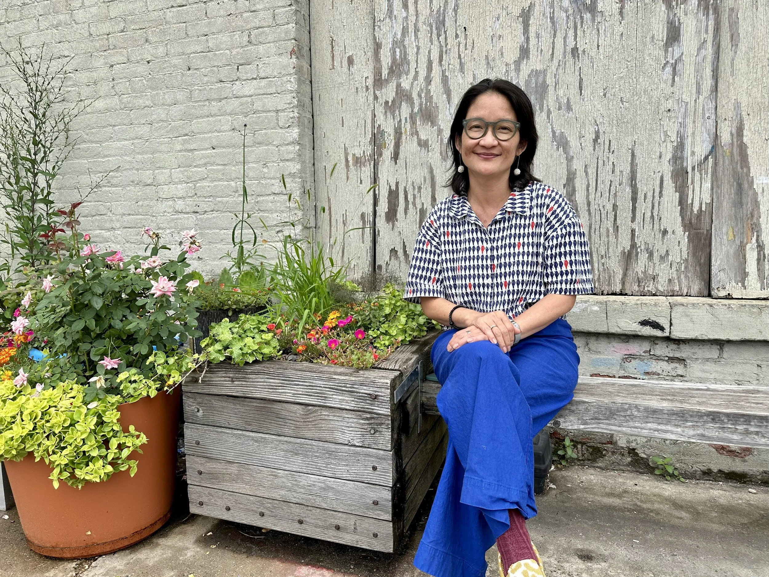 Ann Yonetani sitting in her garden