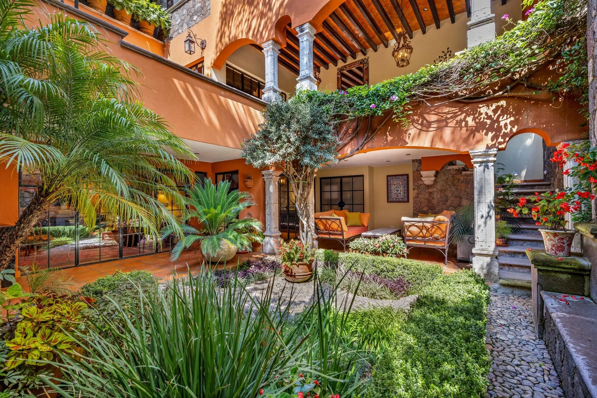 Luxury garden view of a colonial-style home in San Miguel de Allende with landscaped grounds and outdoor living space