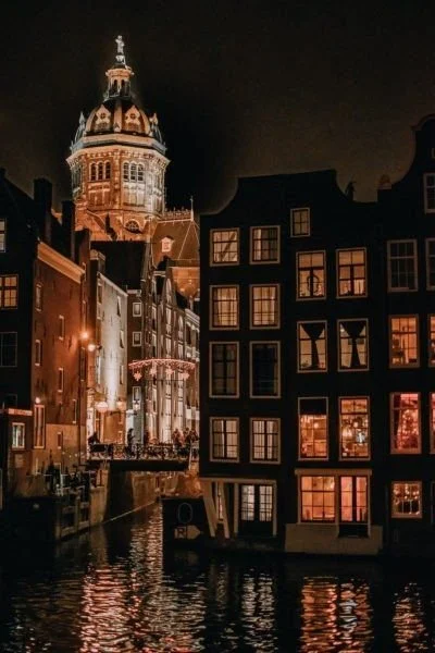 Amsterdam's canals and architecture at night.