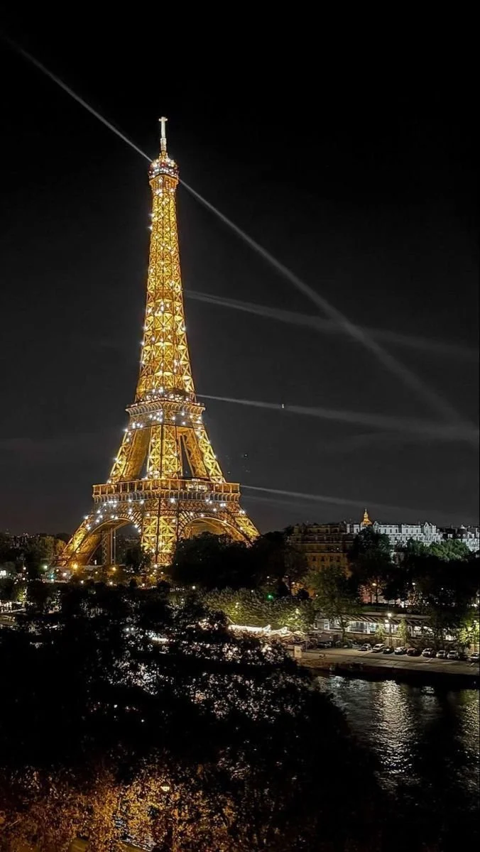 Eiffel Tower night view of the Seine and sparkling tower.